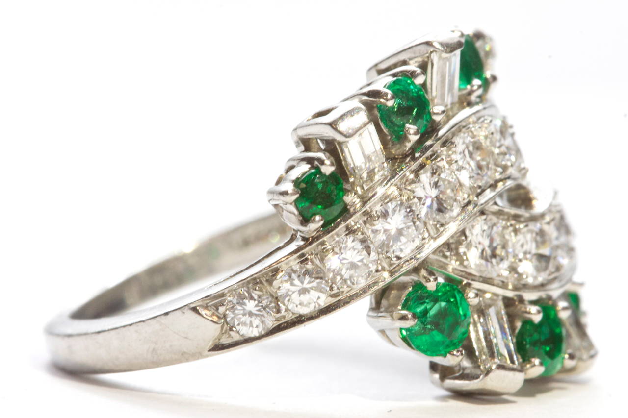 A beautiful and tasteful weaving design from Tiffany. The color combination of white round and baguette cut diamonds and round cut green emeralds is truly easy on the eye. Crafted in platinum,

Signed Tiffany & Co.