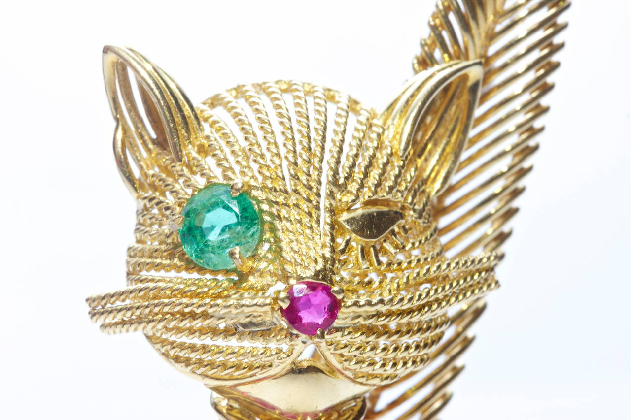 Tiffany created this fun and rare winking cat that is dressed with rubies and emeralds, making this animal completely irresistible. Crafted in 18k yellow gold and is signed and numbered.