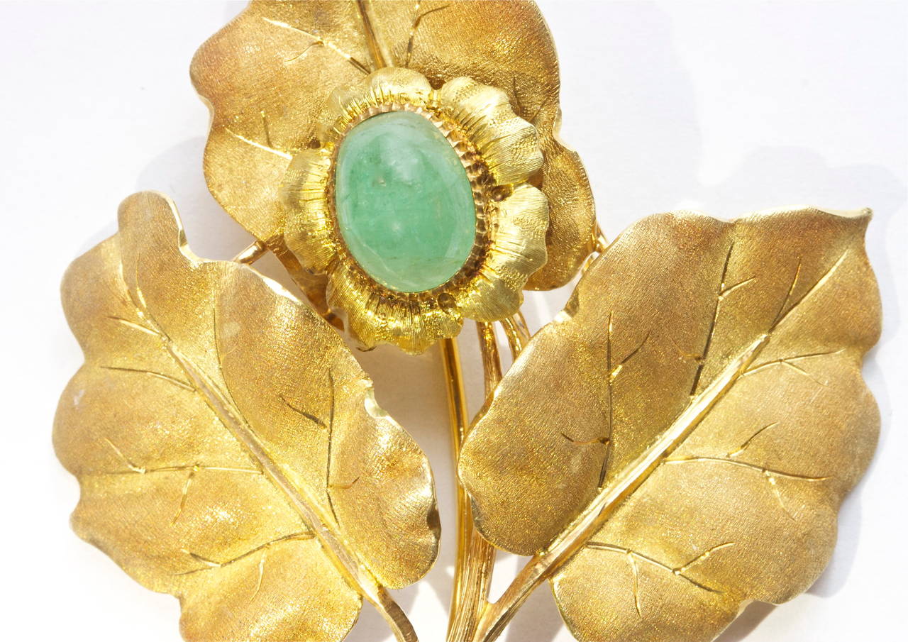 Another distinctive, creative and delicate design from Mario Buccellati. Carefully hand crafted in 18k gold with with the usual emphsis on detail.The center stone is a cabochon emerald.  
The brooch is signed and numbered.