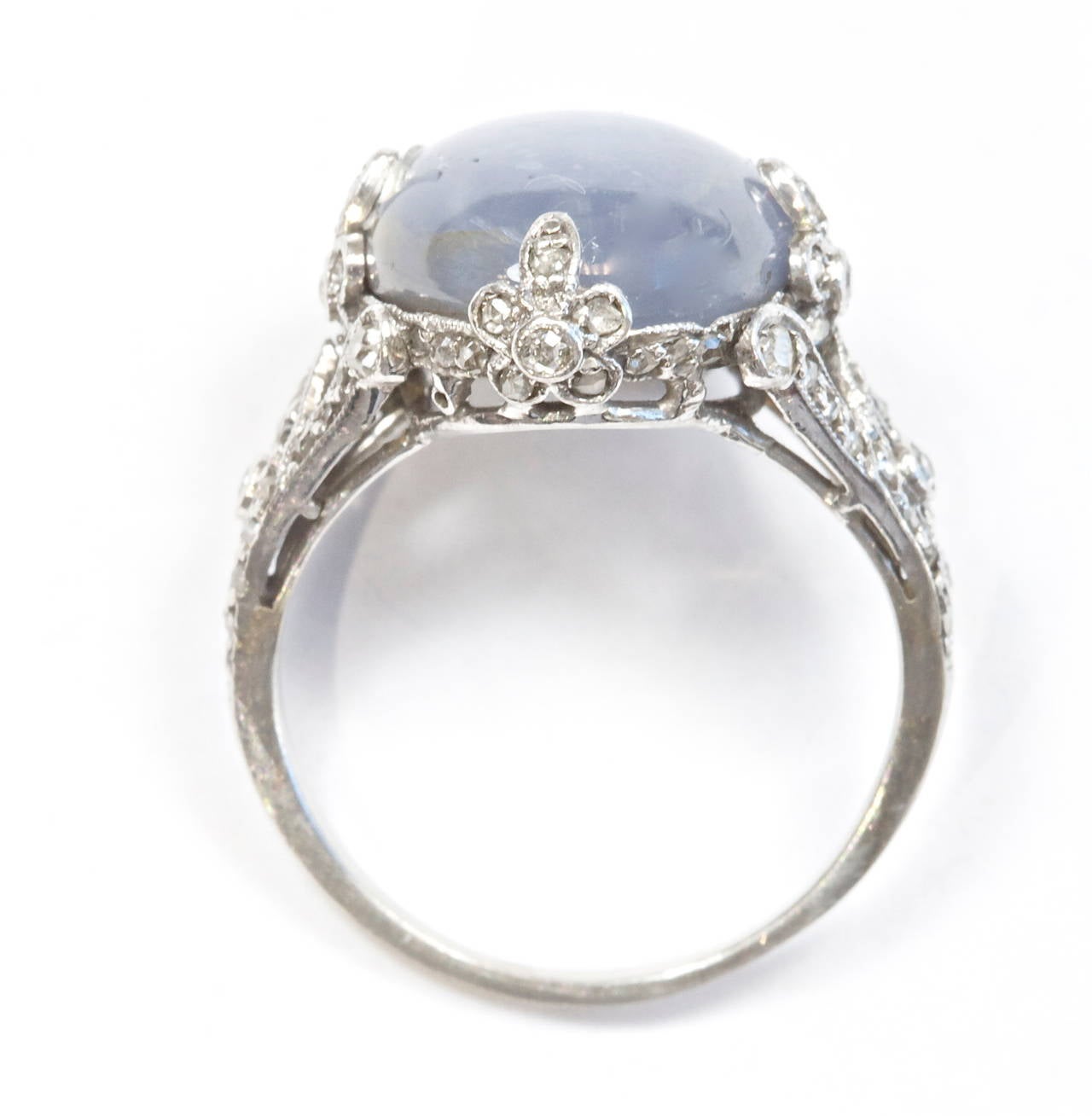 A well defined star blue grey sapphire that weighs approximately 13 carats. Set in a detailed hand made art deco diamond platinum ring.

Ring size 6 and can be resized.