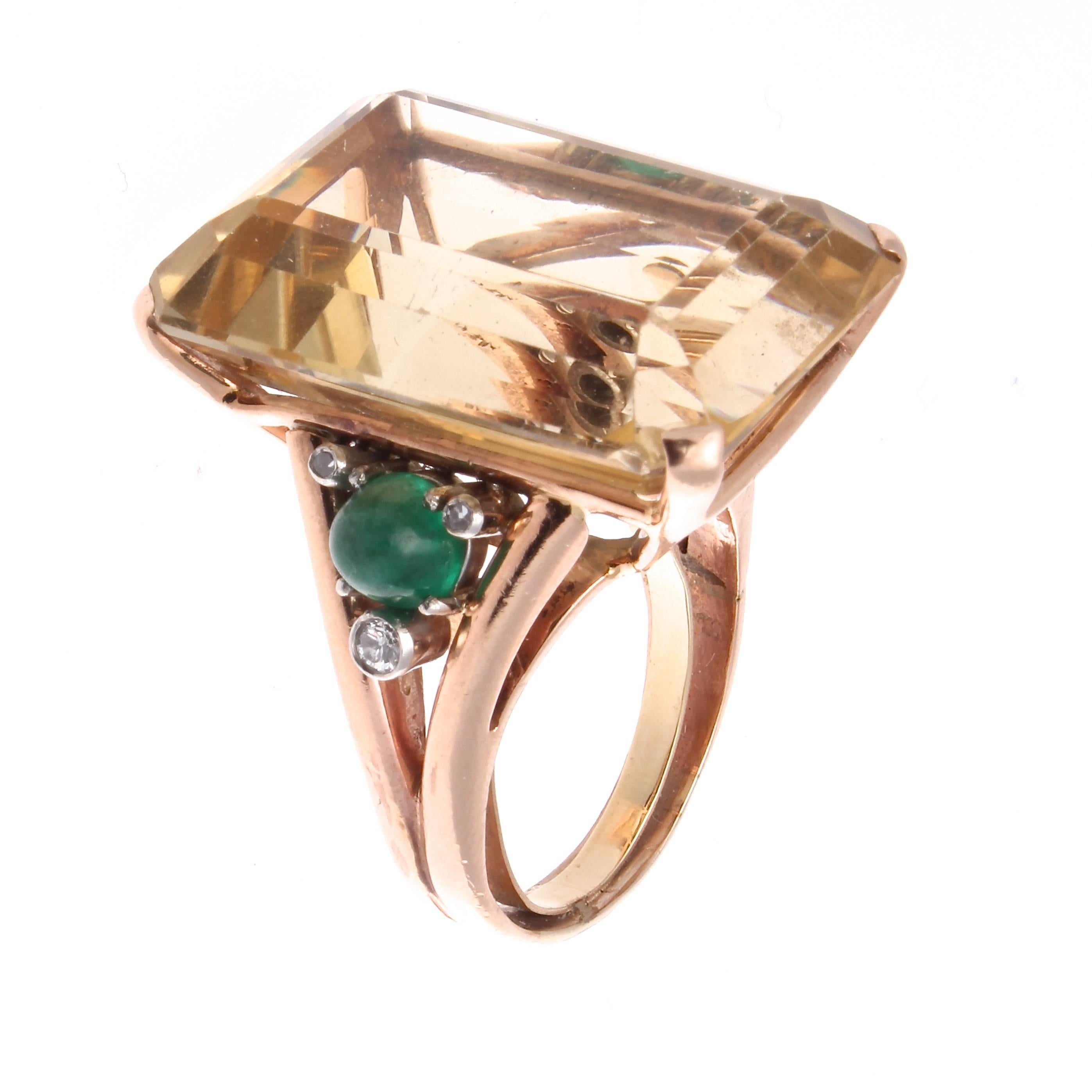 The 1940's was an era where bigger was better. The large glowing golden citrine is been accented by a lovely cabochon emerald that is surrounded by 3 white, clean diamonds on either side. Hand crafted in a 14k rose gold ring,  a popular style in