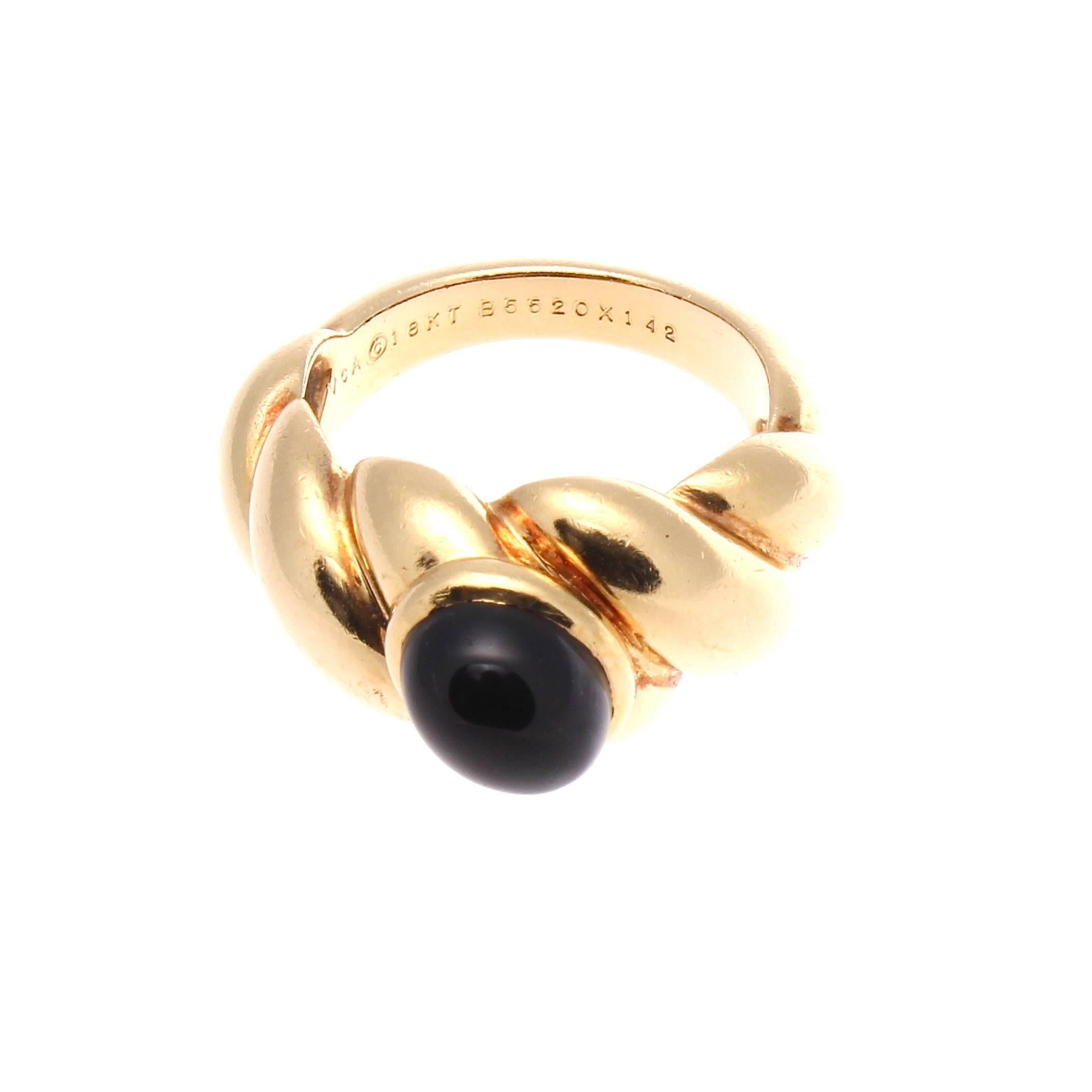 Van Cleef & Arpels, a long rich history of trend setting fashion that is still relevant today. The ring has been designed with a jet black cabochon onyx that is bezel set in gentle rolling hills of 18k yellow gold. Singed VCA and numbered.

Ring