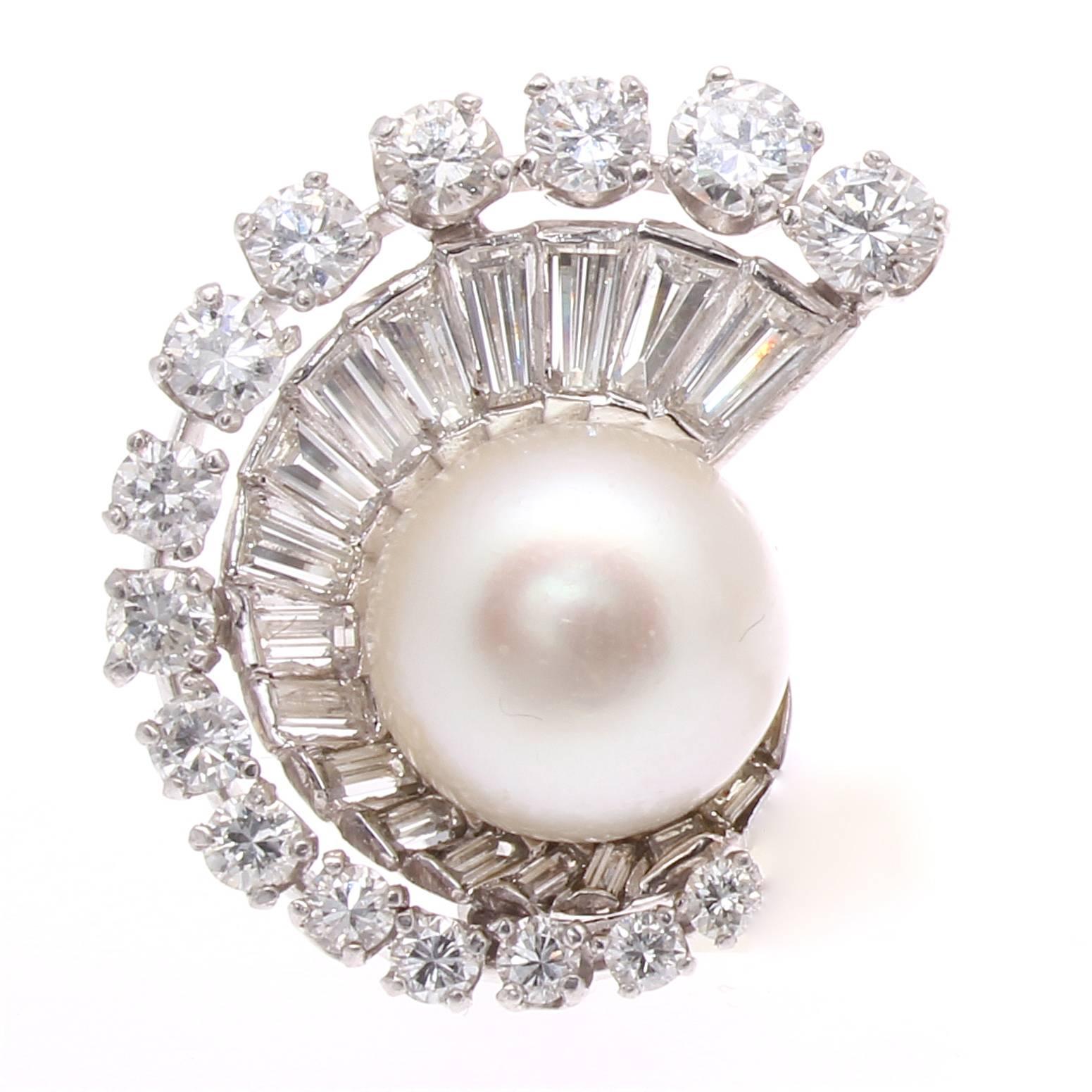 An exquisite art deco creation that has been developed in a way that features perception of depth through design. Decorated with a single cultured pearl in each earring that is drawn in by the swirling layers of baguette and round cut clean, white