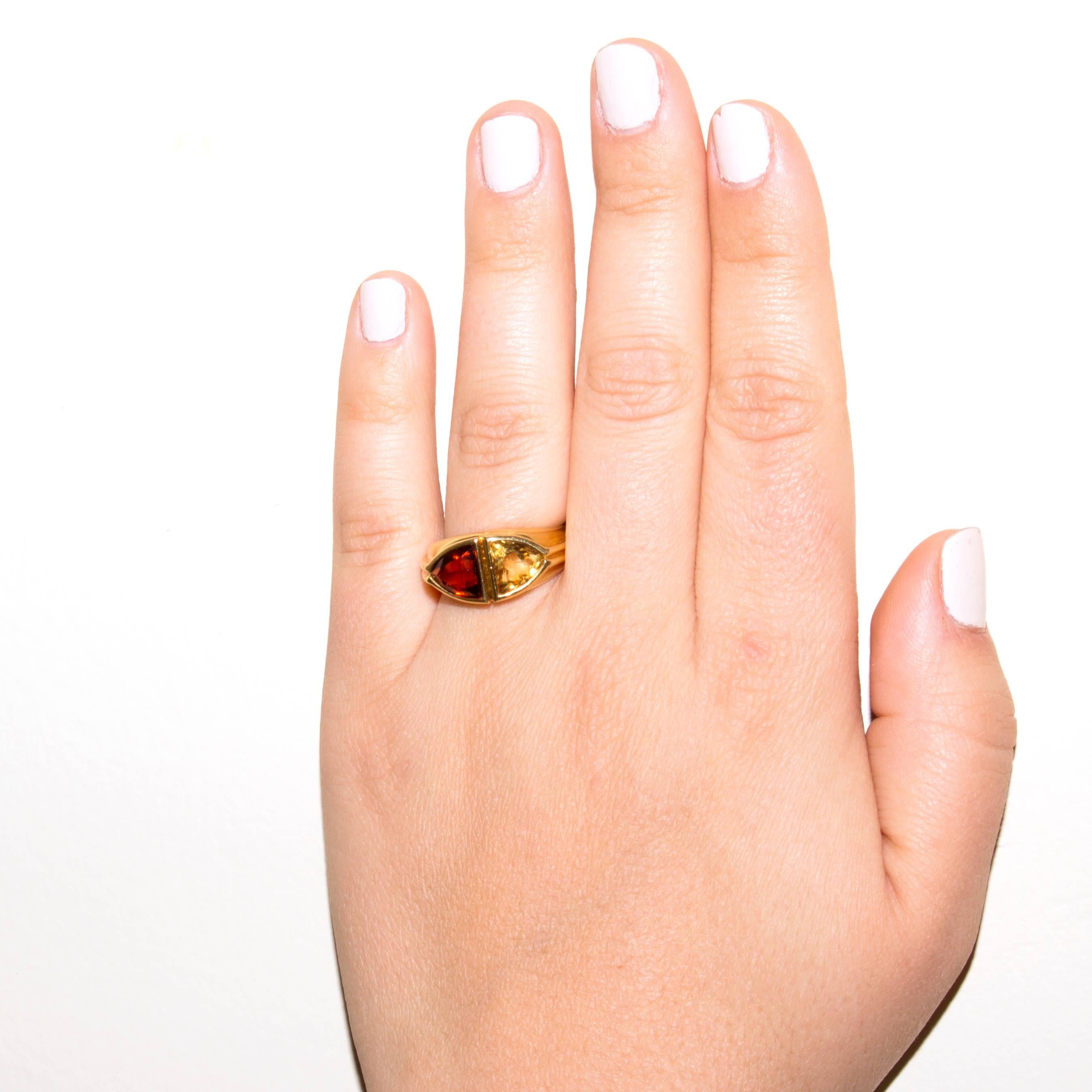 Stylish and colorful from Bulgari. Designed with a burnt orange citrine and a vibrant yellow topaz set amid contours of 18k gold. Signed Bvlgari. Ring size 6 and may be resized.

