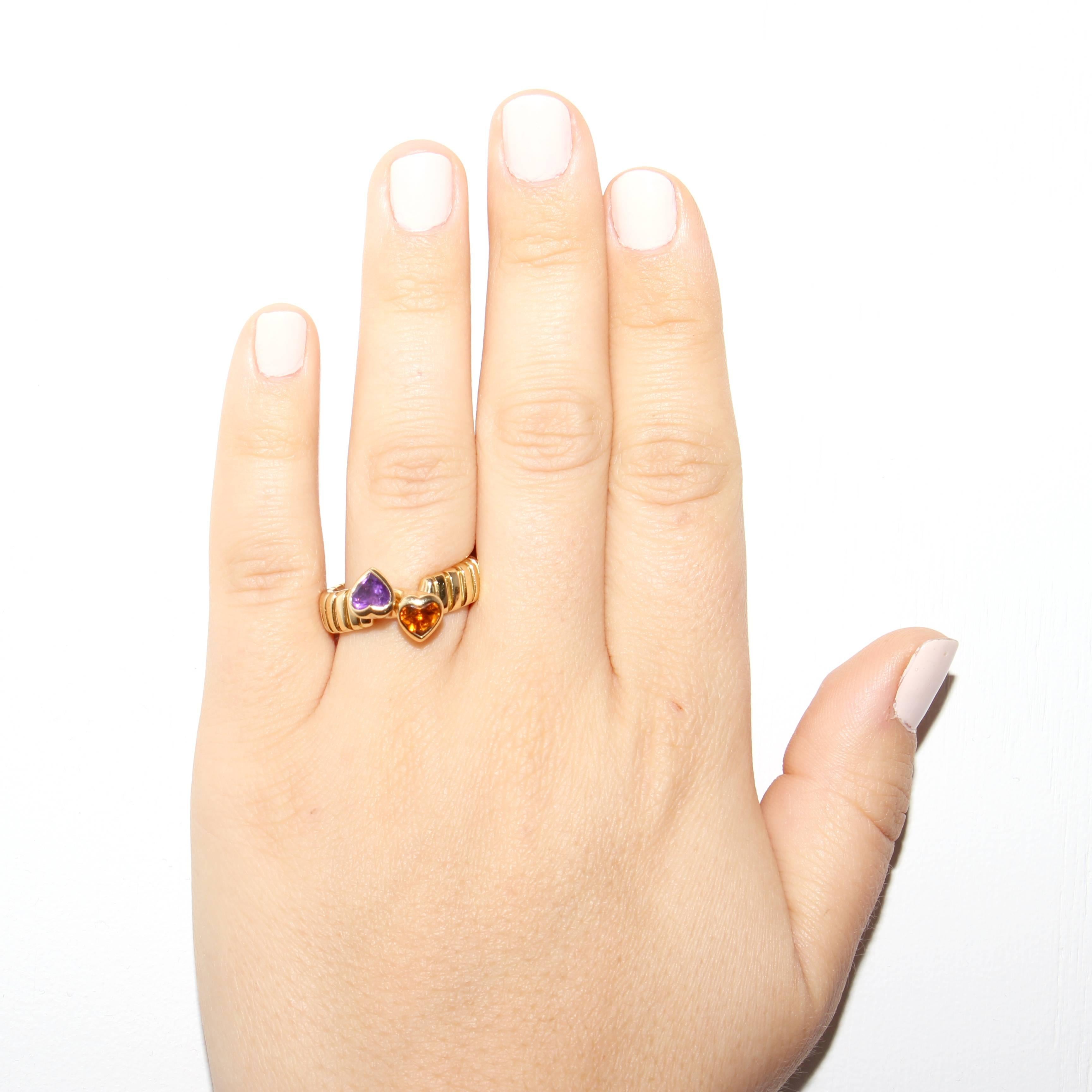 Stylish and colorful from Bulgari. Designed with a purple amethyst and a golden citrine set amid ribbed sections of 18k gold. Signed Bvlgari. Ring size 7.
