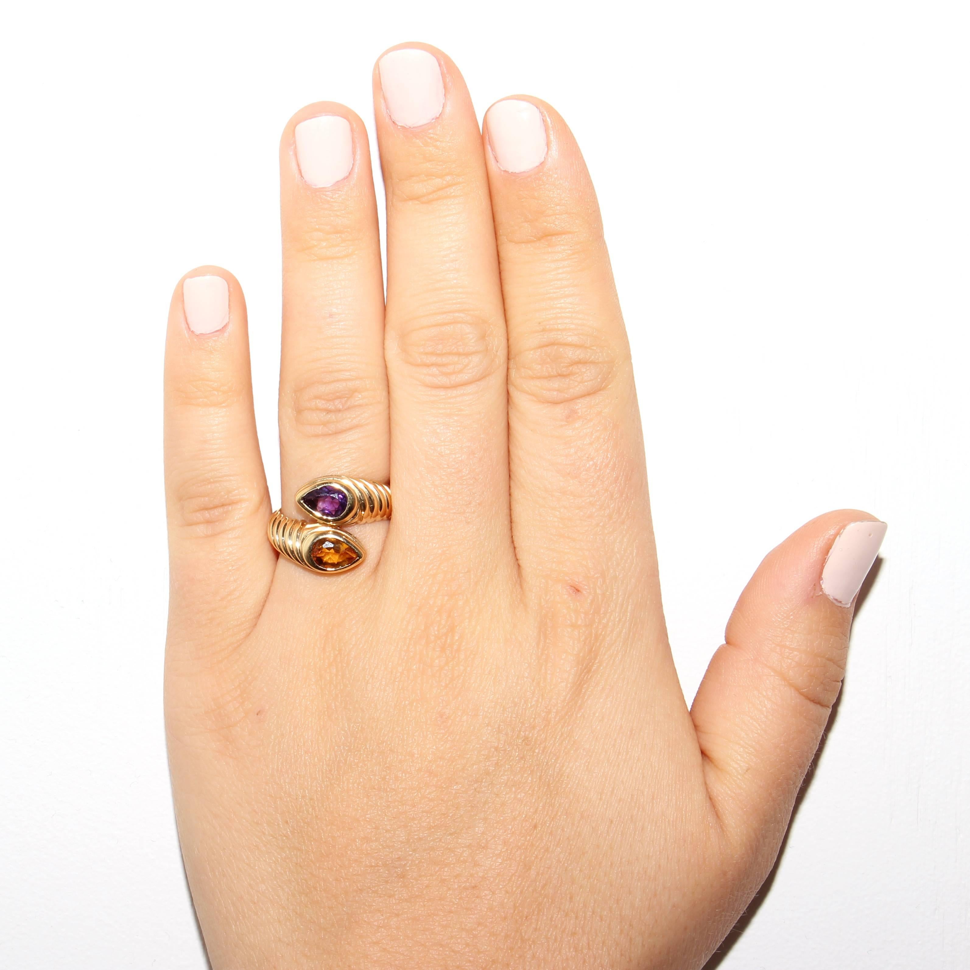 Stylish and colorful from Bulgari. Designed with a golden citrine and a purple amethyst set amid rolling contours of 18k gold. Signed Bvlgari. Ring size 6 and may be resized.
