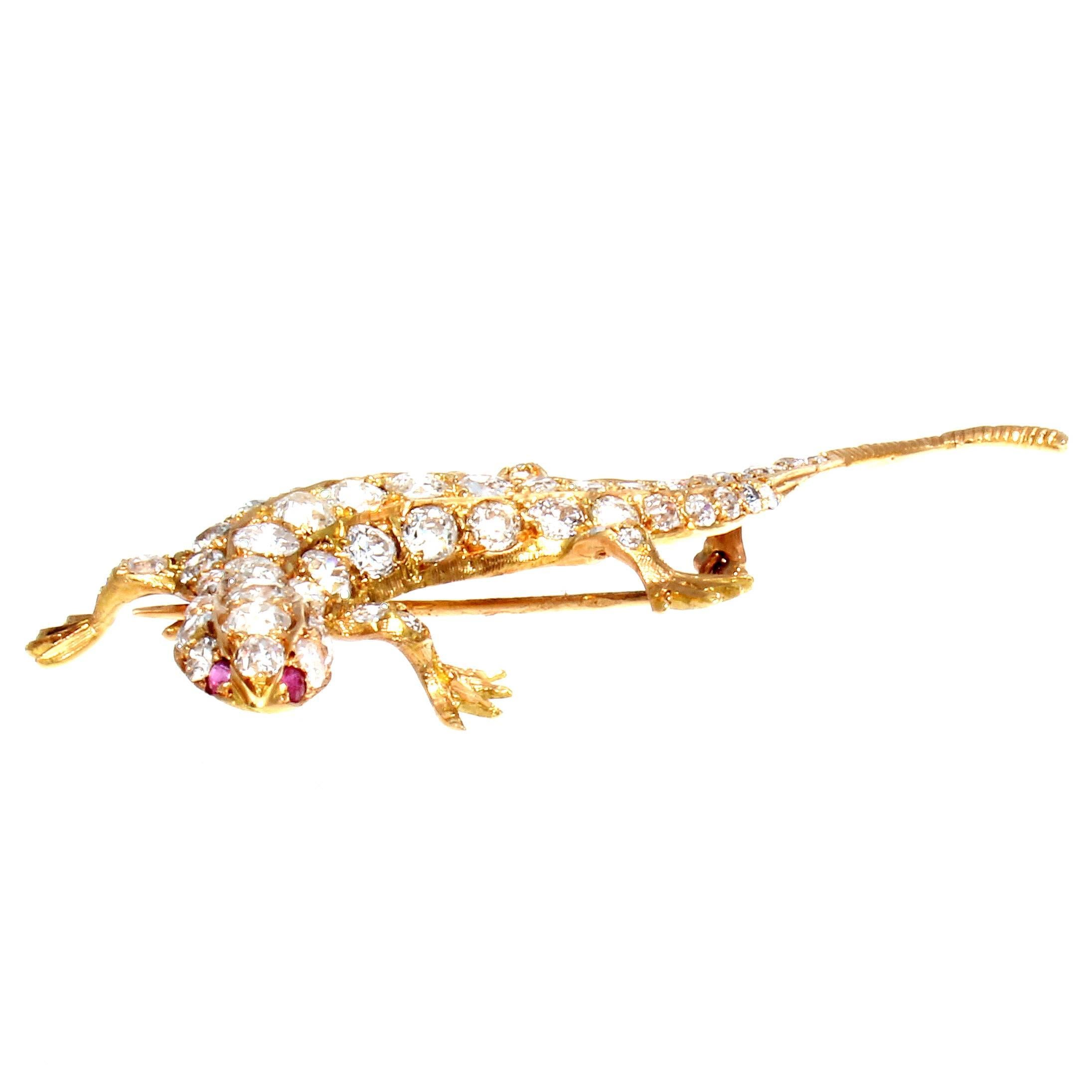 Sensuous and undulating the salamandre is the essence of primordial movement. Featuring 65 near colorless round brilliant cut diamonds weighing approximately 6 carats and two lively red rubies that have all been hand crafted in 18k yellow gold.