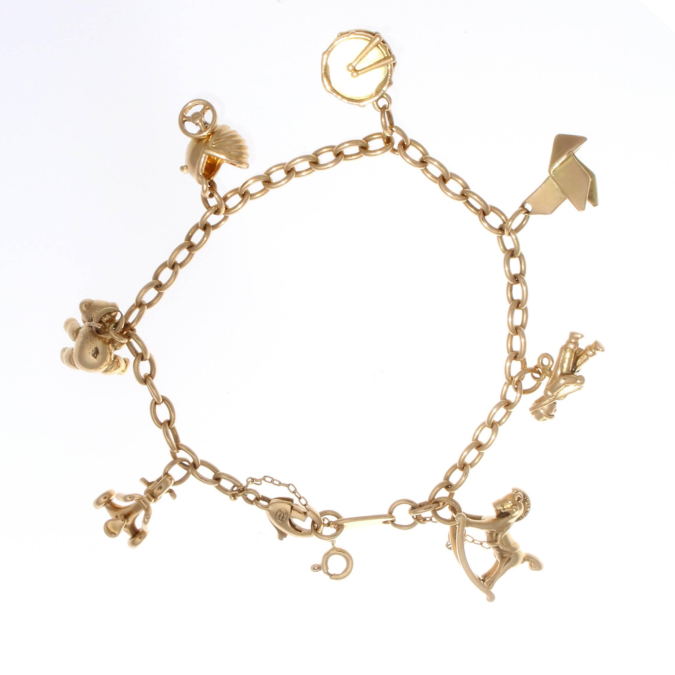 Cartier, elegant and timeless. The bracelet has been decorated with 7 playfull   charms. Crafted in 18k yellow gold. Signed Cartier, numbered and stamped with French hallmarks.