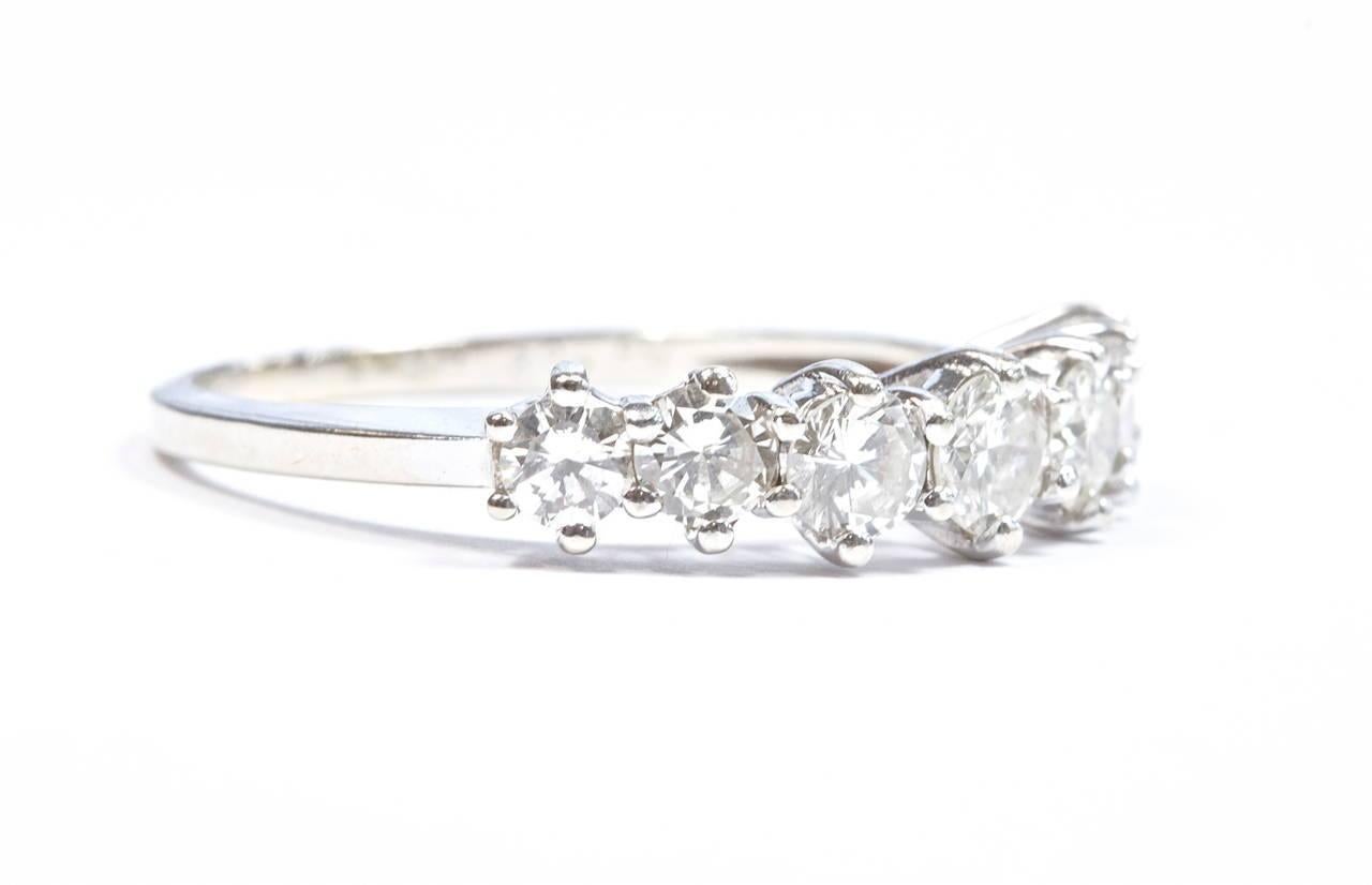 The diamonds are lively in this refined elegant band ring. Designed with 7 diamonds and crafted in 14k white gold. 

Size 8 and can be re-sized.