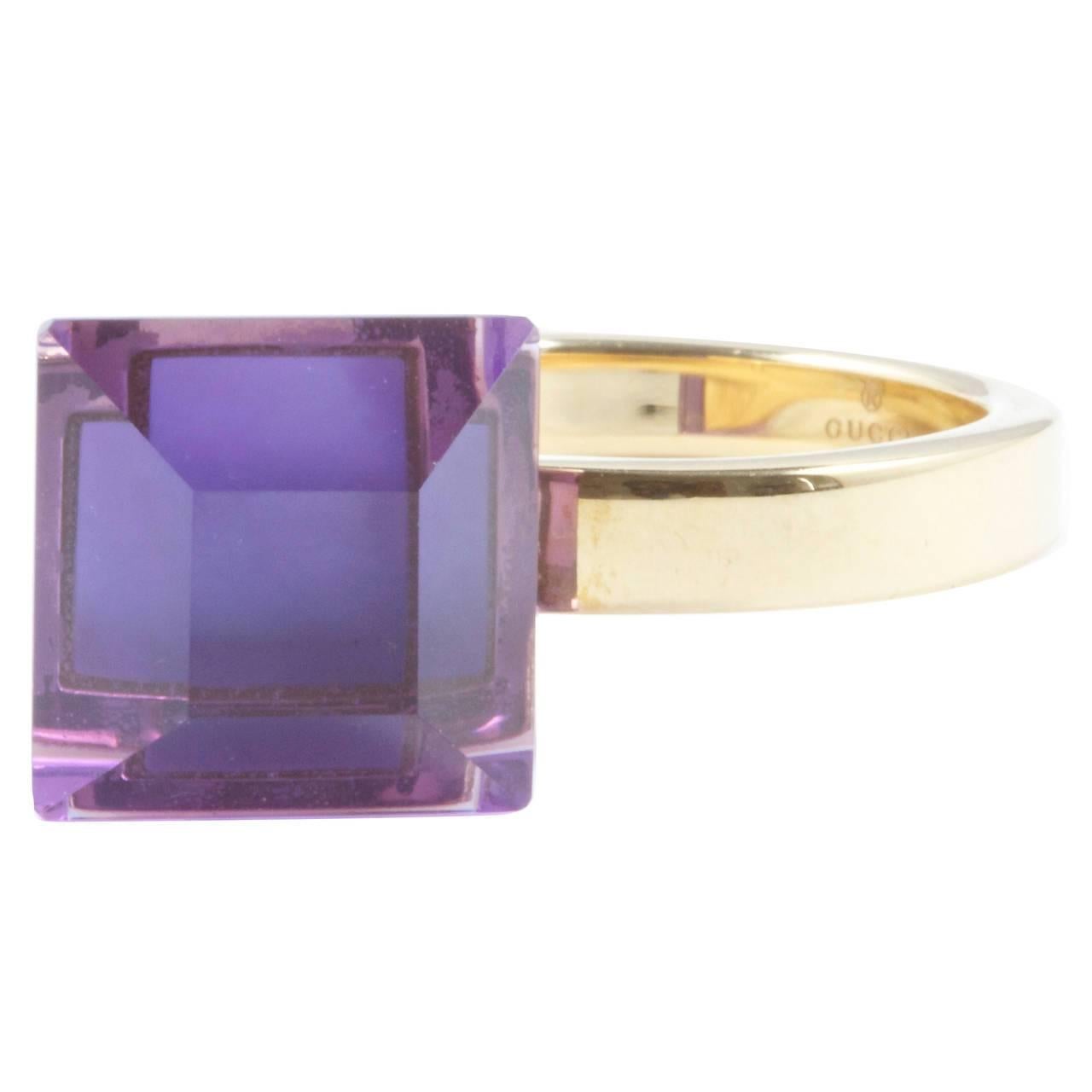 A unique stylistic ring from the fashion forward designers at Gucci. Created with a soothing purple amethyst and fine Italian 18k yellow gold. Signed Gucci and stamped made in Italy.   

Ring size 6 1/2 and can be re-sized.