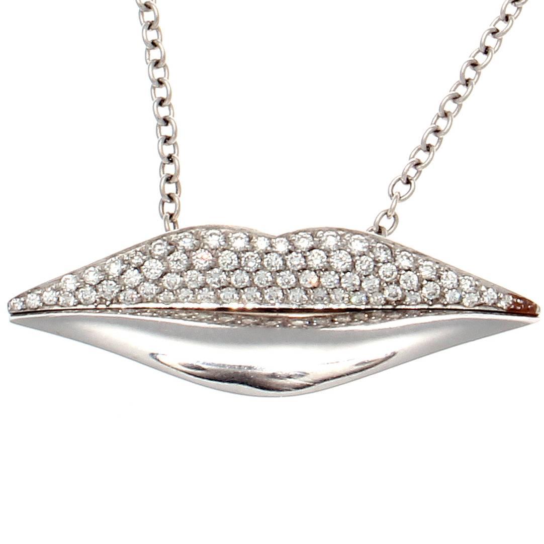 The playful lips are designed in glistening 18k white gold with lively white, clean diamonds. Signed Enigma.

Accompanied with original box.