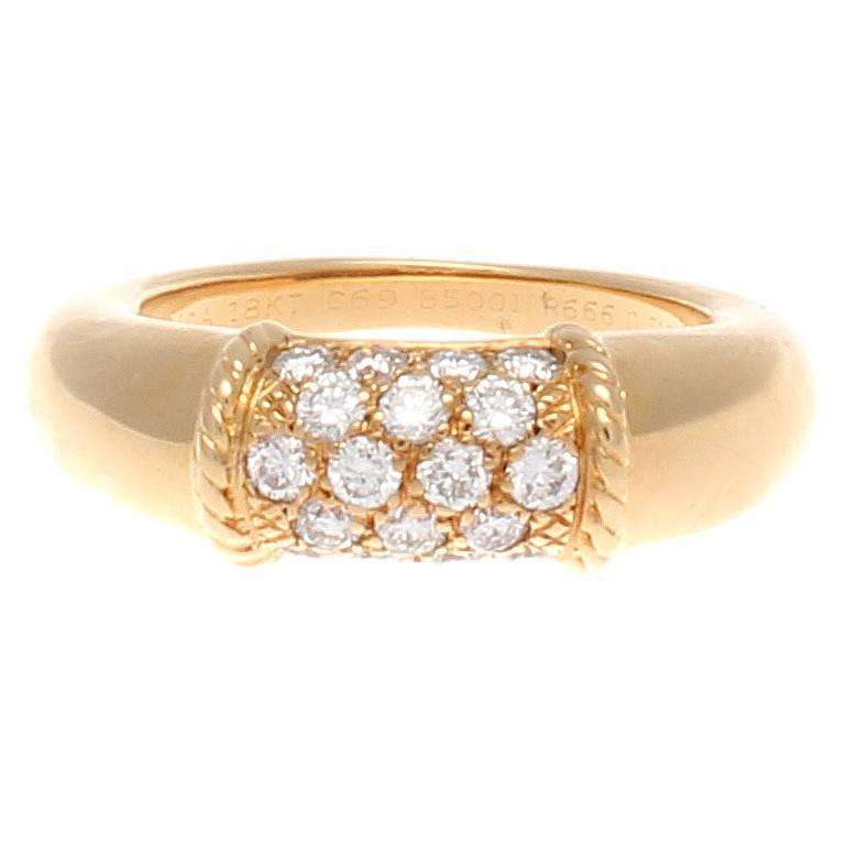 The classic Philippine design from Van Cleef & Arpels. Creating clean, smooth lines of yellow gold that are embedded with a garden of clean, white diamonds accented by textured gold and enclosed by perfectly fitting rope motifs. Signed VCA, numbered