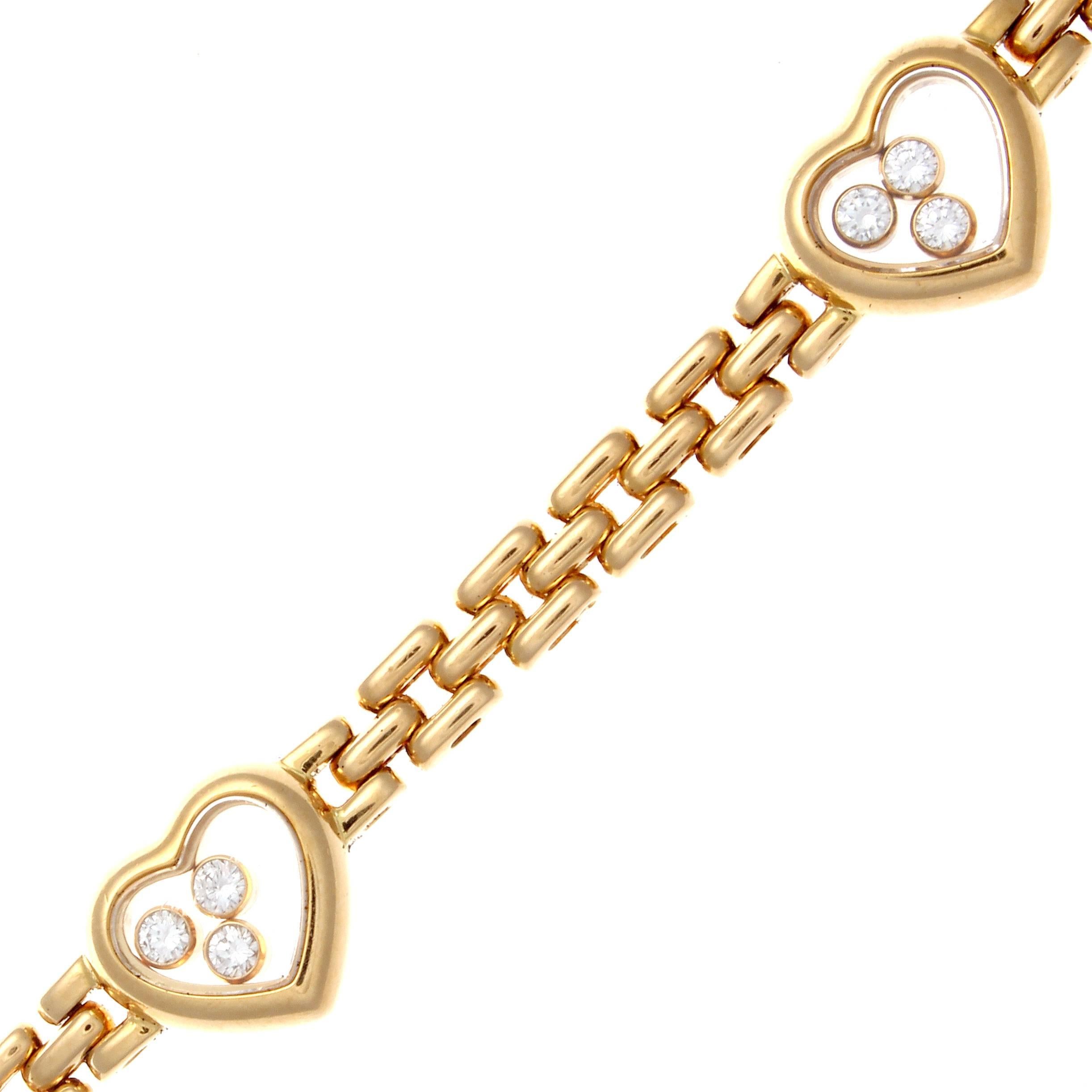 A love filled creation from the happy collection at Chopard. Designed with transparent hearts filled with joy from 3 lively white, clean diamonds in each motif. Crafted in glistening 18k yellow gold. Signed Chopard and numbered.