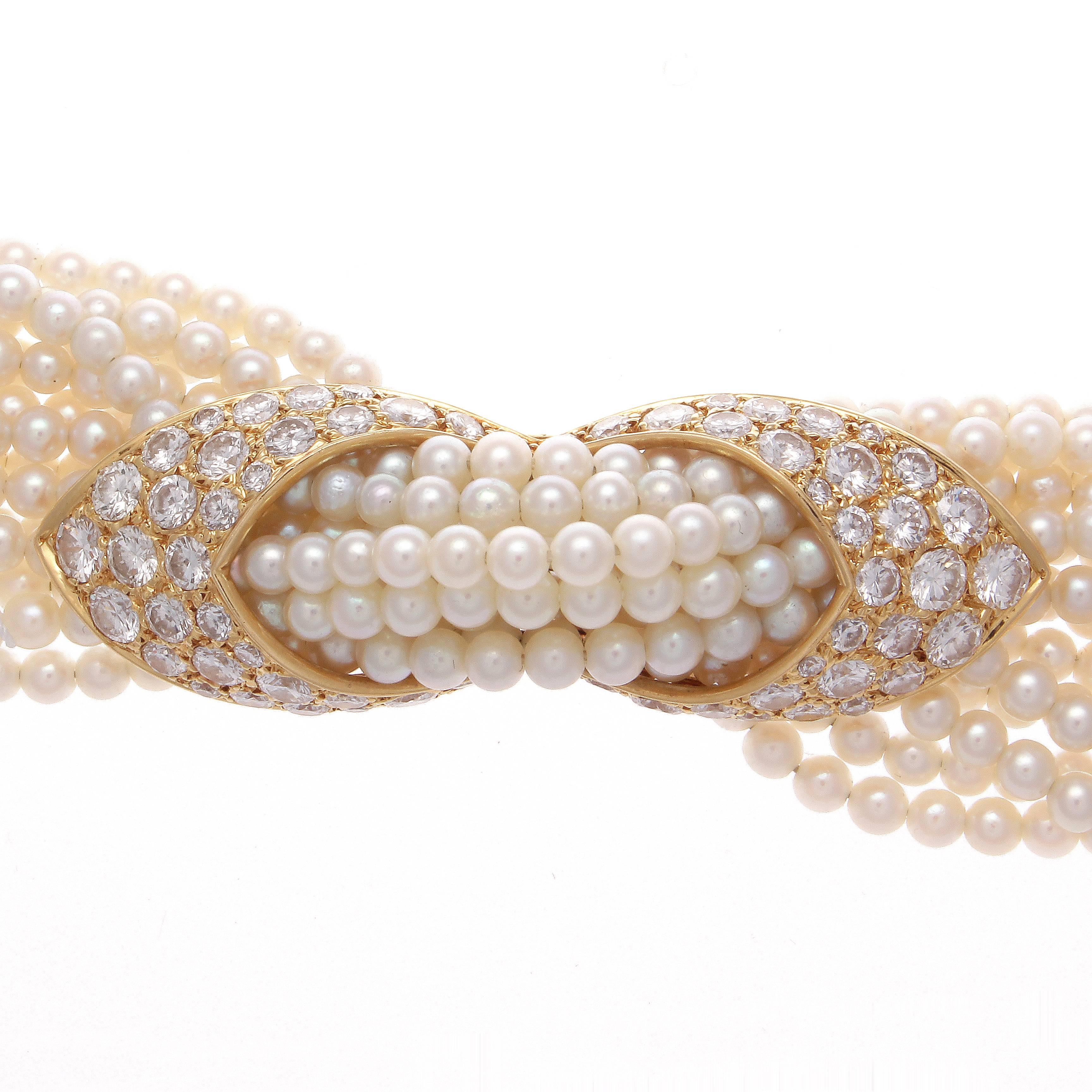 A fabric like seed pearl and diamond bracelet that is comfortable to wear from Cartier. Designed with sinuous strands of silky seed pearls that gracefully glide through the free moving center piece made of diamonds and gold. Perfectly finished with