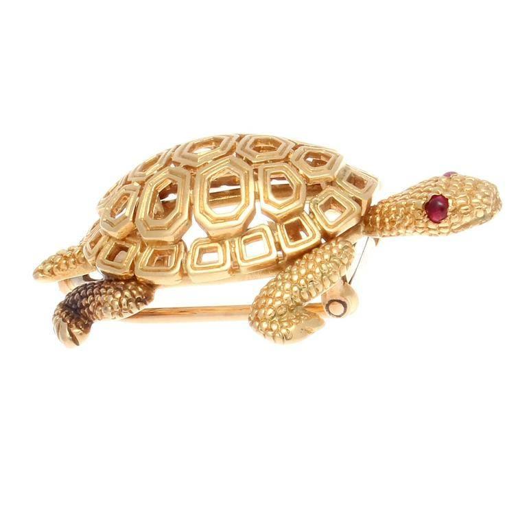 Masterfully created and elegantly realized from Cartier. Designed with a textured gold body and perfectly fitting open hexagons of smooth gold. Finished with ruby red eyes. Signed Cartier Paris.  1-1/2 inches x 1 inch