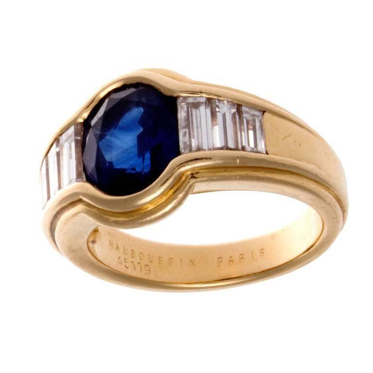 France has always been recognized for its style and fashion and the jewelry created there is no exception. This ring has been designed with a deep vivid blue oval cut sapphire and has been accented by three near colorless baguette cut diamonds on