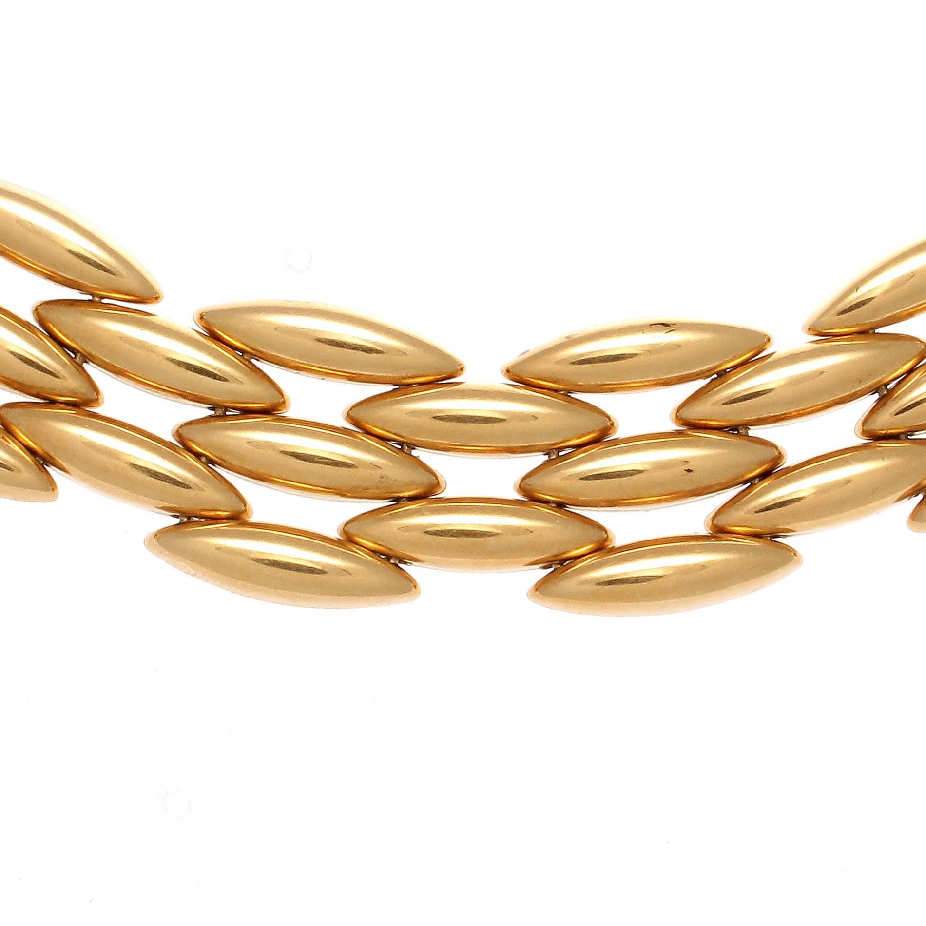 A creation of simplistic elegance. Created with 5 rows of glistening 18k yellow gold from the famous gentiane collection. Signed Cartier.

18 inches in length.

