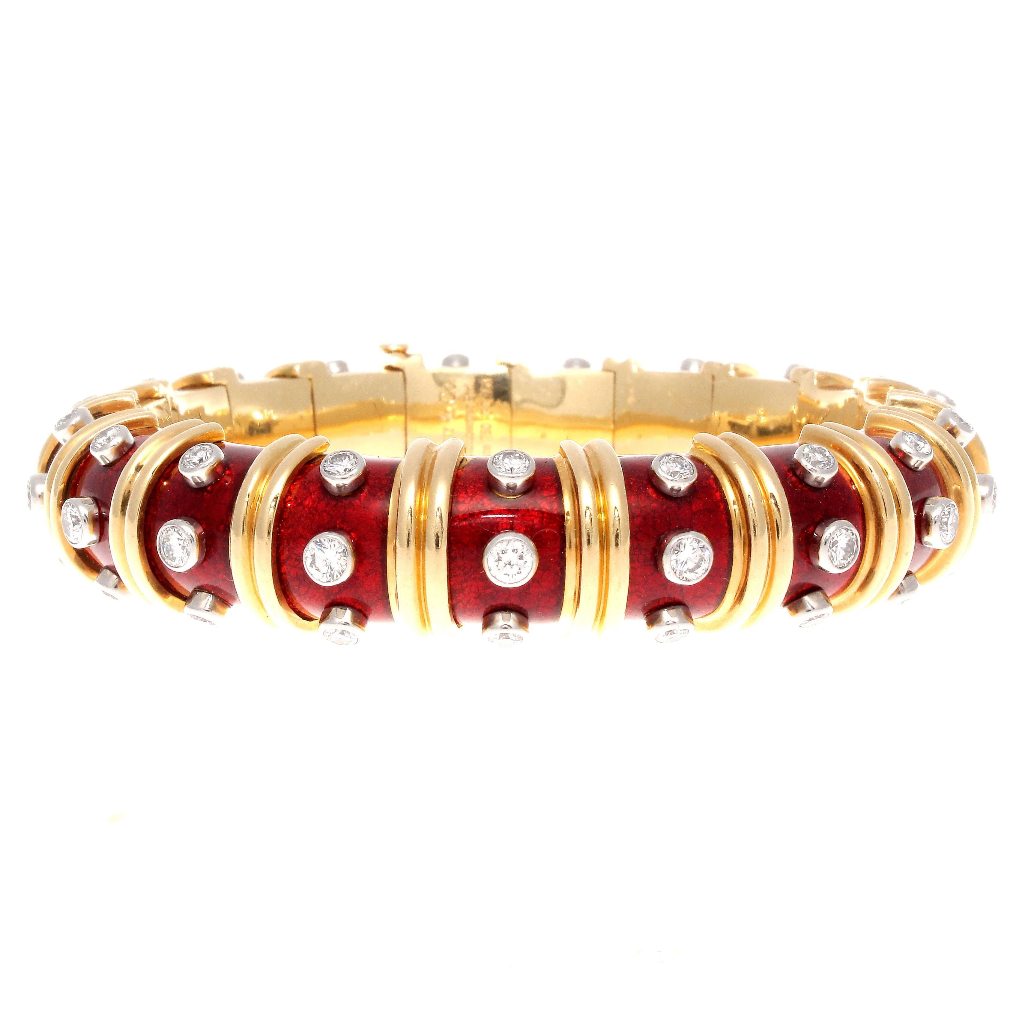 Jean Schlumberger is the top designer from Tiffany and is a master of form. This elegant Paillonne bangle bracelet is created with translucent red enamel, partitioned by ribs of 18k gold perfectly complemented by 57 white, clean diamonds that weigh