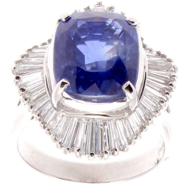 The 7.06 carat sapphire is a rich brilliant blue, and the ballerina styled ring is a perfect platform for displaying the color. The 2 carats of diamonds surrounding the sapphire are white and clean. The sapphire is classified by GIA as Ceylon origin