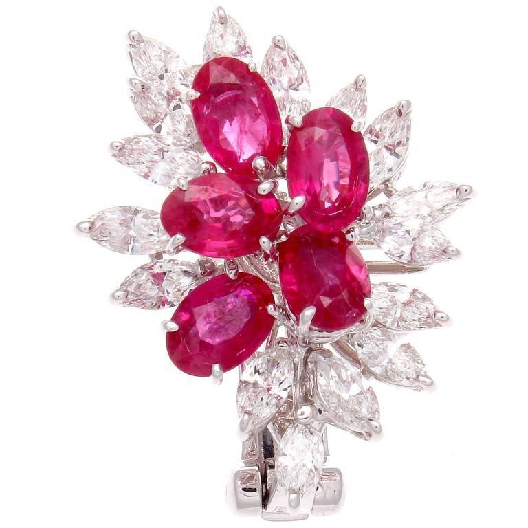 A beautiful array of color coming together to paint this vivid picture. Vibrant red rubies against a backdrop of glistening white diamonds. The earrings feature 10 oval cut rubies with an approximate weight of 4.50 carats, and 32 marquise cut