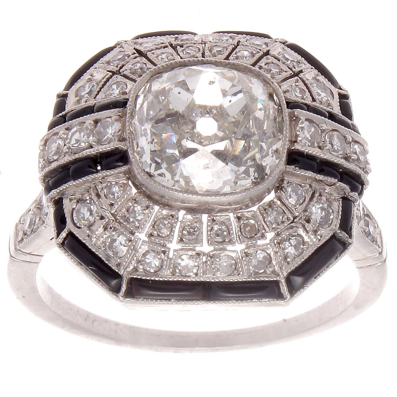 A creation of true excellence inspired by the historic Art Deco period. Featuring an approximately 2.50 carat imperfect old cushion cut diamond that is H-I in color. Accented by a dome of symmetry that is designed with perfectly matching diamonds