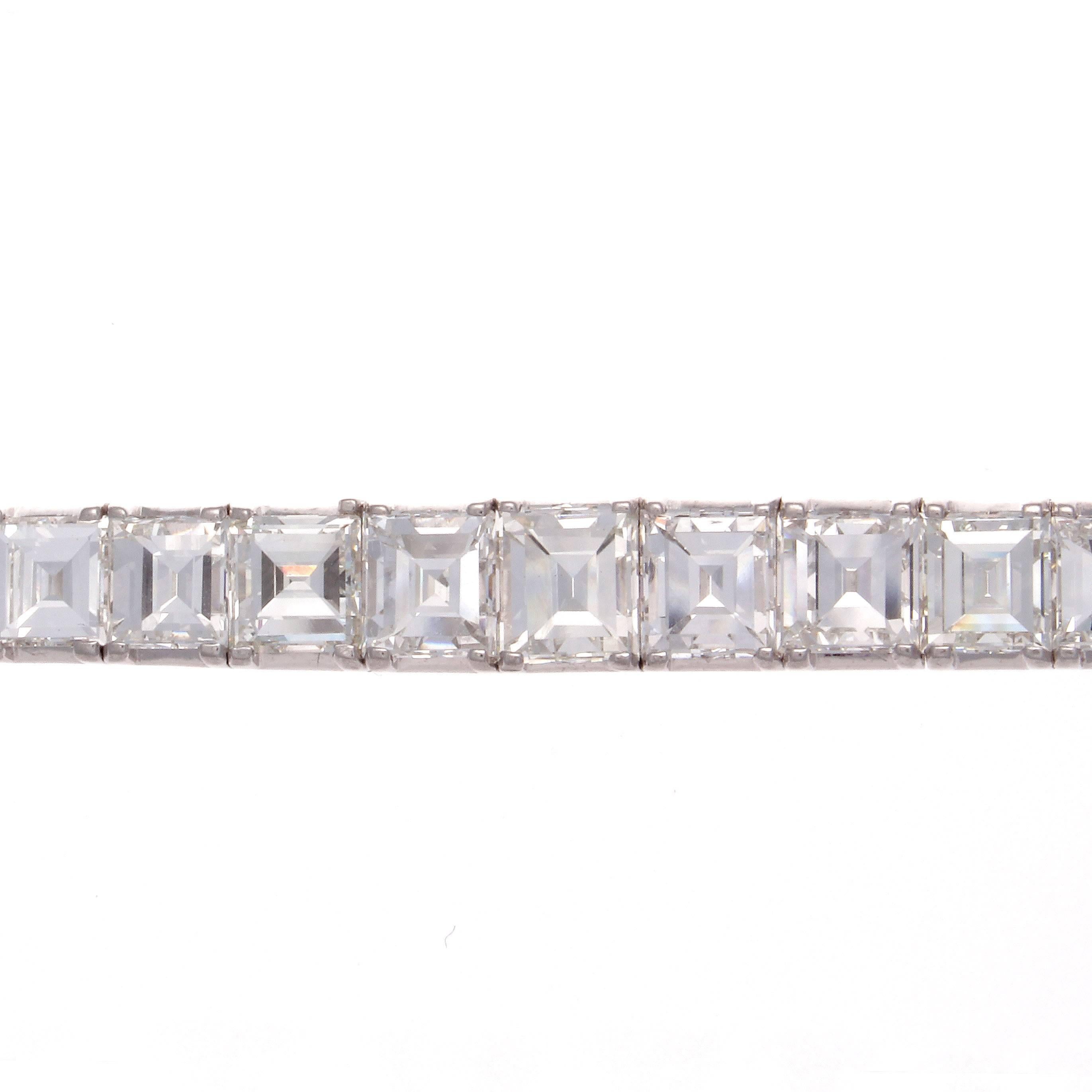 Timeless elegance radiates from this special one of a kind Art Deco diamond bracelet. Designed with 39 perfectly matching rectangular step cuts that are G,H in color VS+ in clarity and having a total approximate carat weight of 28 carats. The 9