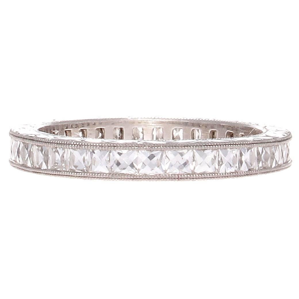 A timeless elegance radiates from this diamond platinum eternity band. Featuring perfectly matching white, clean french cut diamonds weighing approximately 1.50 carats and are perfectly channel set in the filigree platinum ring. 
Ring size 5 3/4.