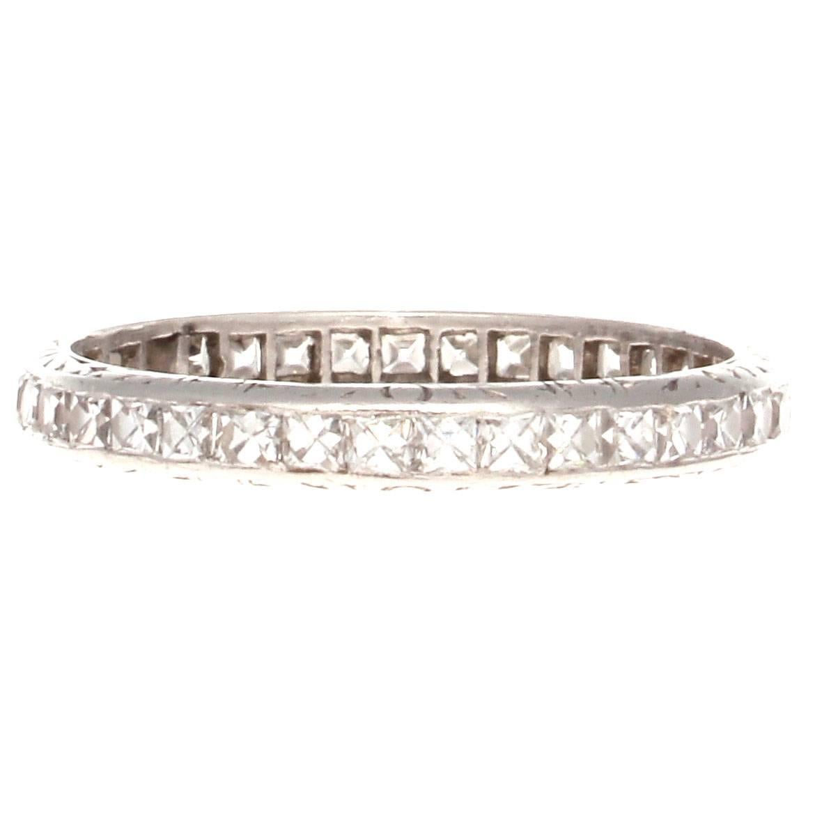A timeless elegance radiates from this diamond platinum eternity band. Featuring perfectly matching white, clean french cut diamonds weighing approximately 1.10  carats which are perfectly channel set in the filigree platinum ring. 

Ring size 7.