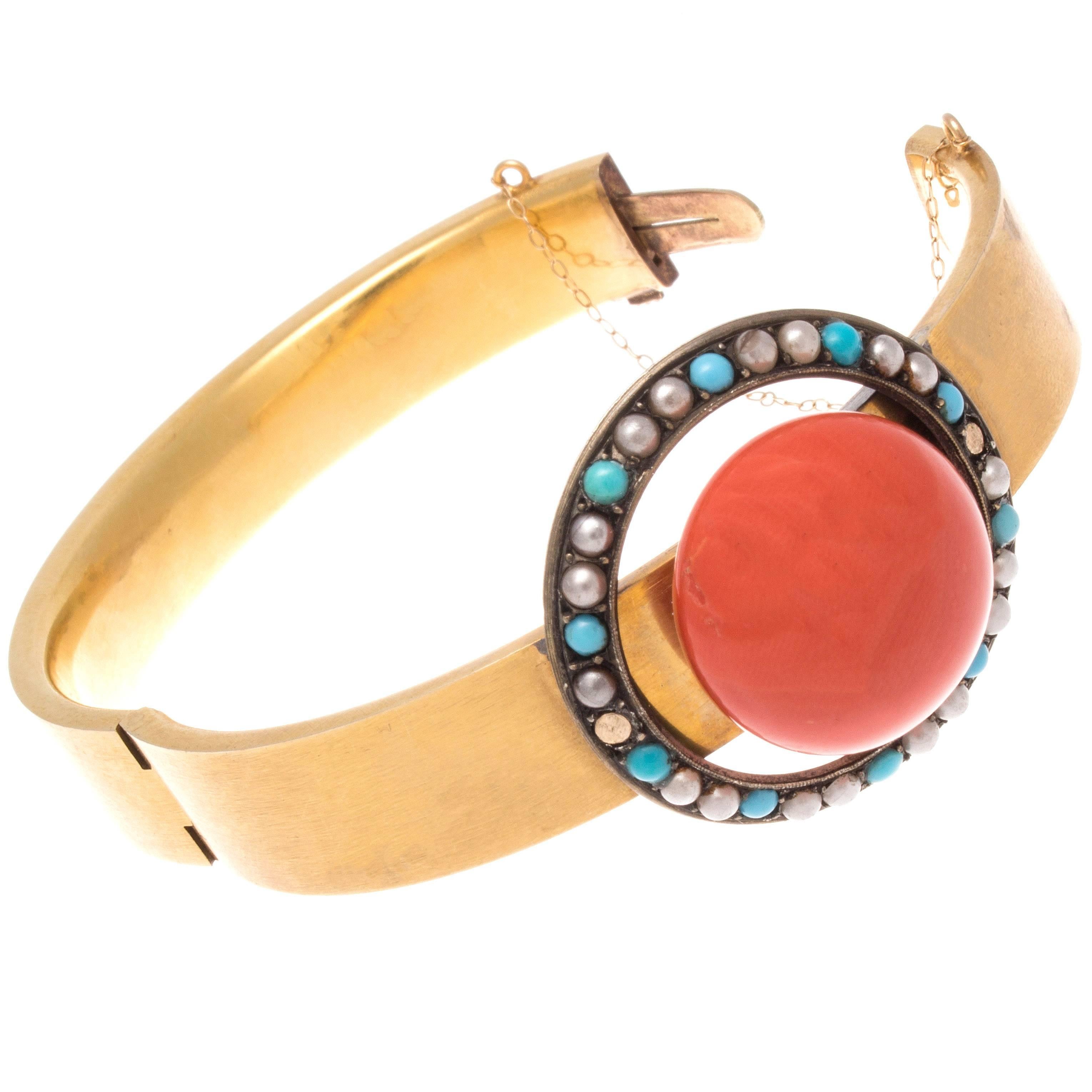 A lovely victorian creation of color. Created with a glowing cabochon orangish-red coral that is surrounded by a halo of bright blue turquoise and creamy pearls. Crafted in 14k gold and silver.

The coral has a diameter of approximately 3/4 of an