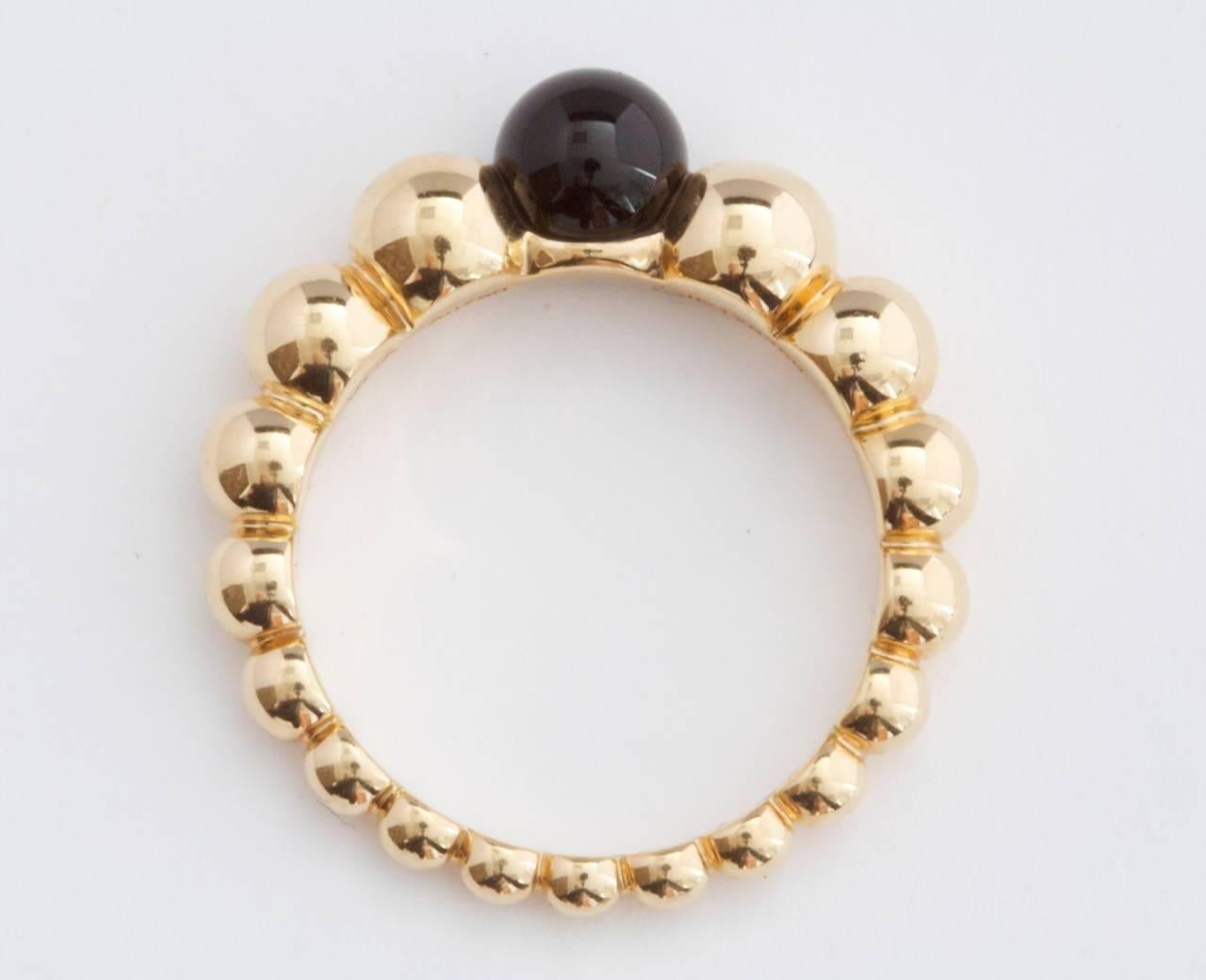 Van Cleef & Arpels, a long rich history of trend setting fashion that is still relevant today. Fashioned with a jet black bead of onyx that is nicely complemented by descending beads of 18k yellow gold. Signed VCA and numbered.   

Size 51 or 5-3/4