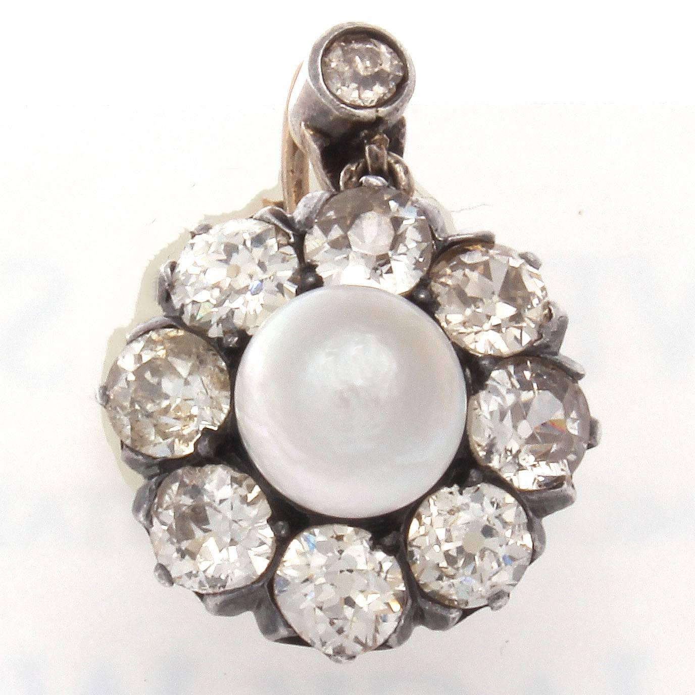 A cluster of tasteful elegance designed with two lovely drops that each feature a beautiful white natural pearl that are surrounded by 8 old European cut diamonds. Hand crafted in silver and gold.