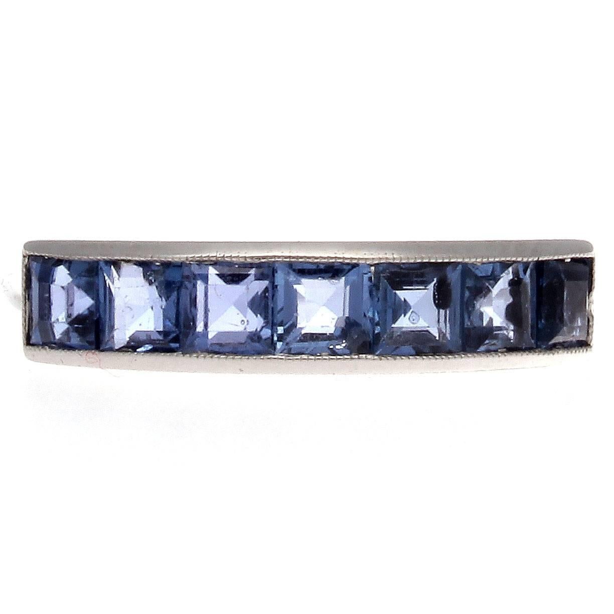 A vivaciously colorful Art Deco treasure. Designed with 7 masterfully matched blue sapphires weighing approximately 1.00 carat. Excellently hand crafted and channel set in platinum.

Ring size 5-3/4 and may be resized.