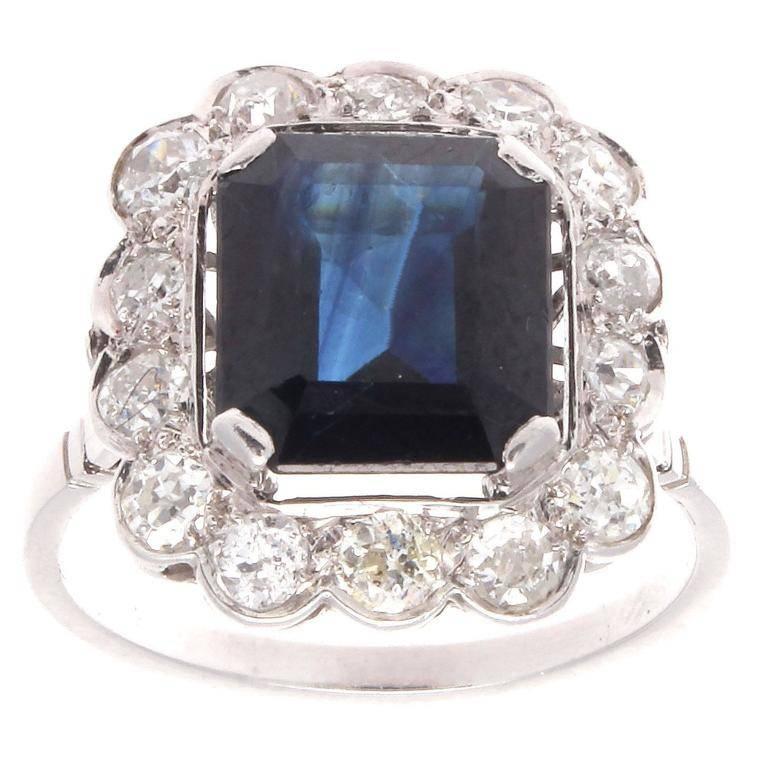 A stylish creation of pure artistry from Paris. Featuring a deep blue emerald cut sapphire that has been elegantly surrounded by a halo of near colorless diamonds. Hand crafted in platinum.  

Ring size 6-3/4 and may be resized to fit.