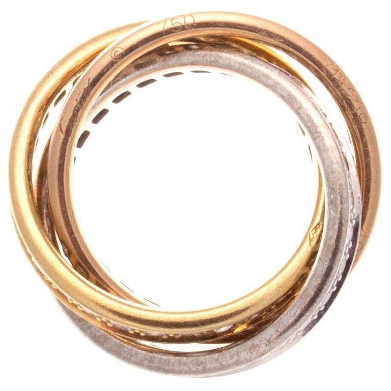 A timeless celestial design from Cartier. Created in the famous tricolor gold: pink gold for love, yellow gold for fidelity and white gold for friendship, intertwined in a display of mystery and harmony. Designed with 96 diamonds free flowing