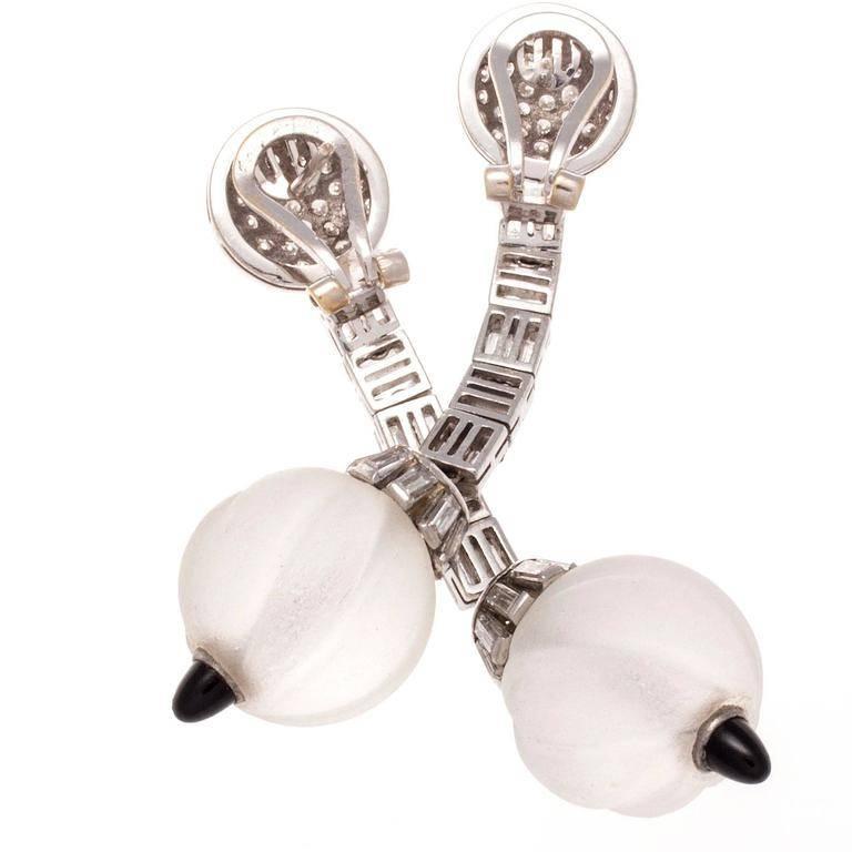 Stylish drop earrings that are elegantly designed and realized. Featuring numerous round and baguette cut diamonds cascading down to the translucent creamy orbs of rock crystal. Perfectly finished with cabochon cut jet black onyx. Hand crafted in