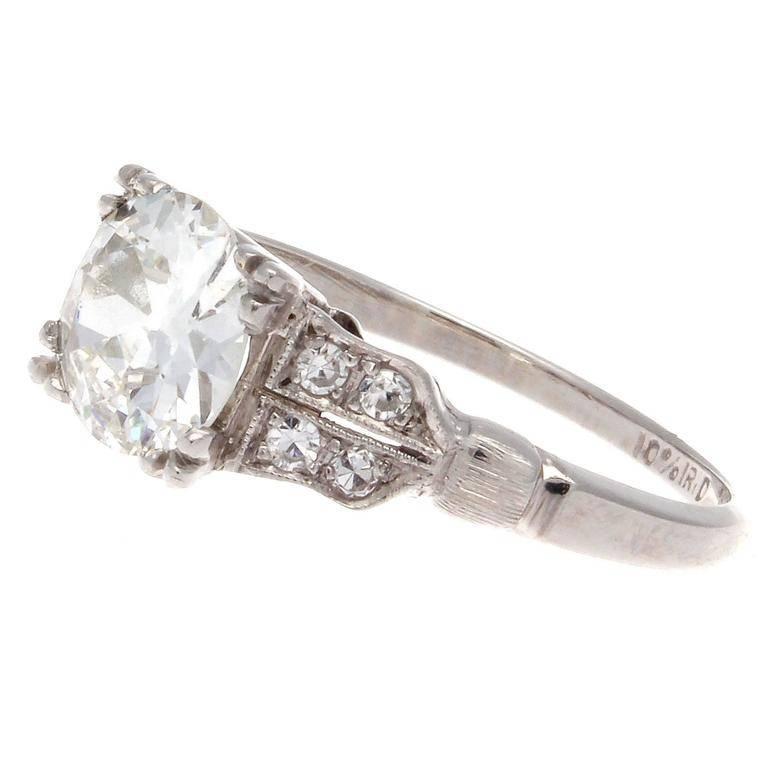 Elegance in its purest form. Created during one of the most iconic eras of antique jewelry with designs that exemplifies its beauty. Featuring a GIA certified 1.05 carat diamond that is graded as G color VS1 clarity. Lifted on either side by two