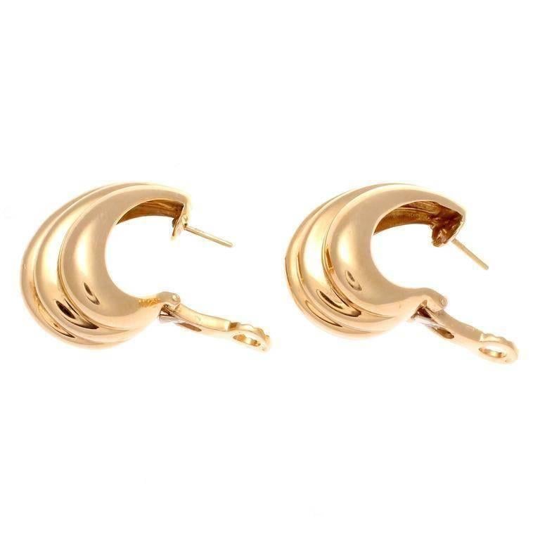 Cartier, elegant and timeless. The ascending contours of rolling 18k gold elegantly fan out in these bright earrings. Signed Cartier and numbered.