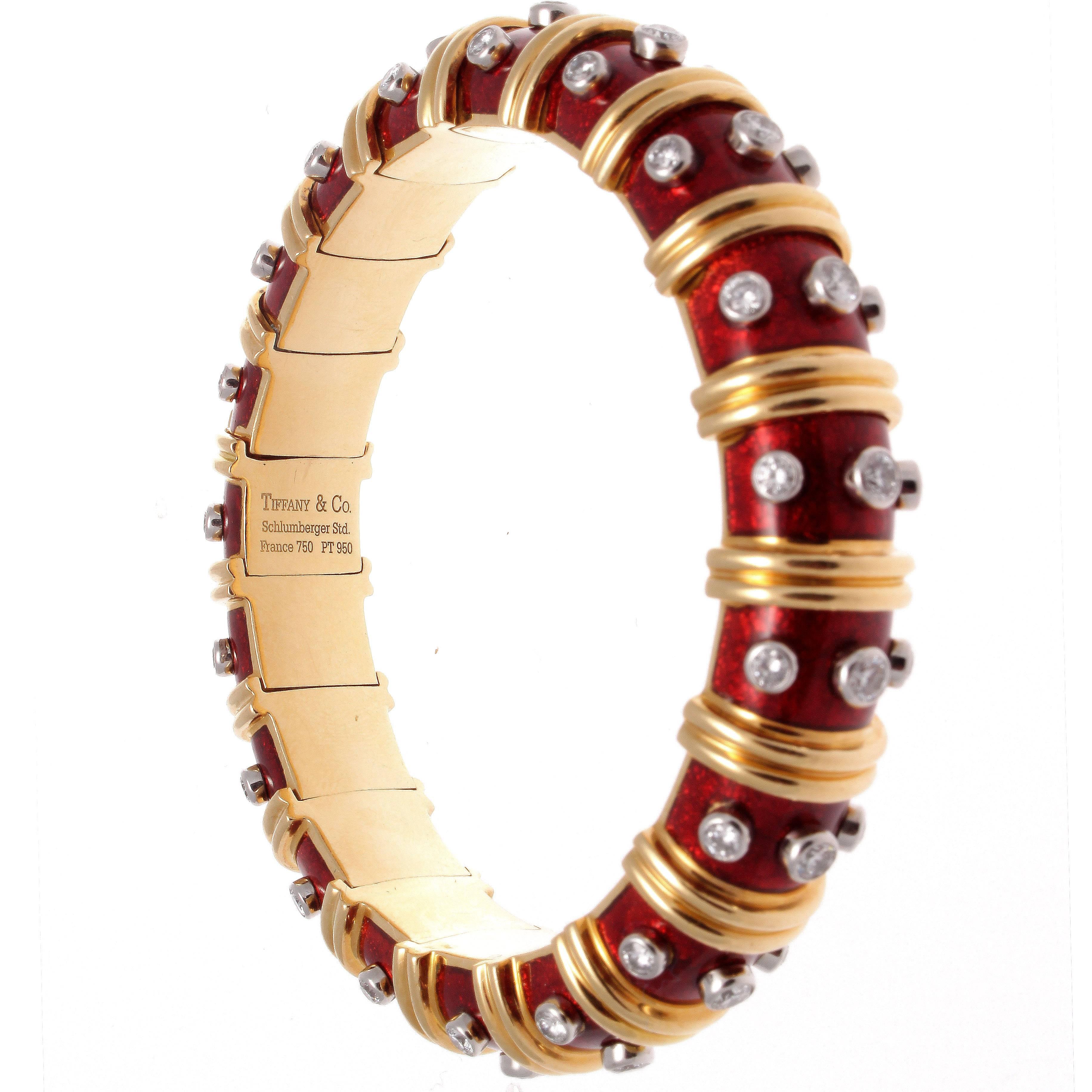 Jean Schlumberger is the top designer from Tiffany and is a master of form. This elegant Paillonne bangle bracelet is created with translucent red enamel, partitioned by ribs of 18k gold perfectly complemented by 57 white, clean diamonds that weigh