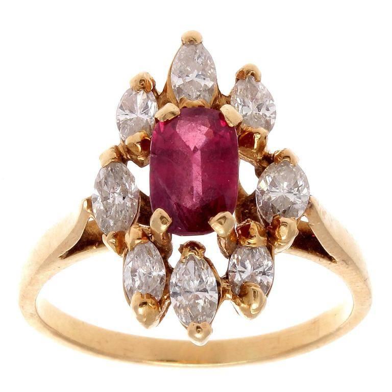 Designs influenced by Queen Victoria during her infatuation for King Charles which was later recognized as the romantic period. Featuring an oval cut deep crimson red ruby that is surrounded by a halo of marquise cut white diamonds. Hand crafted in