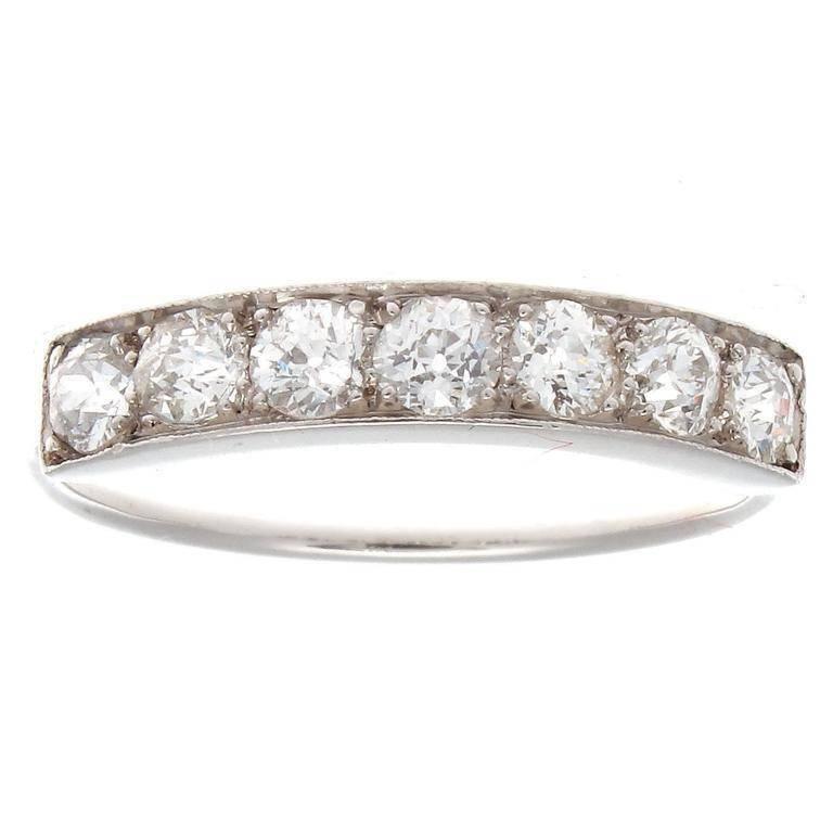 Art Deco's delicate elegance. Featuring 7 perfectly matching diamonds weighing approximately 0.50 carats and are F-G color, VS+ clarity. Hand crafted in platinum.  

Ring size 5-3/4 and may be resized to fit.