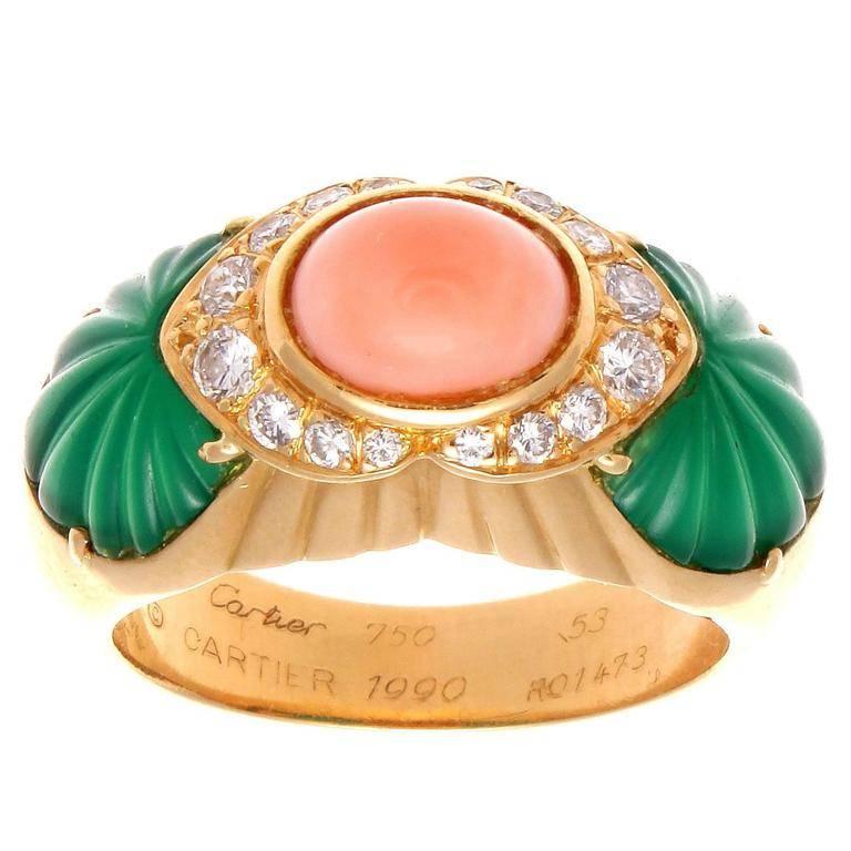 With Cartier's expertise and know how they have been fascinating jewelry collectors with their superior designs for centuries. Creating an explosion of color with a perfect combination of pink angel skin cabochon cut coral accented by shoulders of