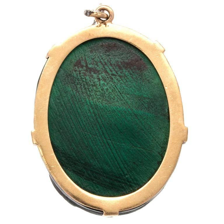 A fascinating pictorial creation magnificently carved out of multi colored malachite. Before cameras the only way to capture a still photo was by paintings and sculptures. Antique cameos usually depicted famous or superior people in the community.