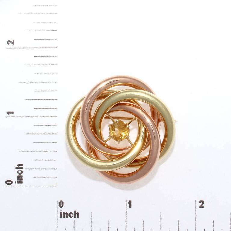 Elegantly intertwining rose and yellow gold that is freely orbiting the center golden citrine. Signed Tiffany & Co.