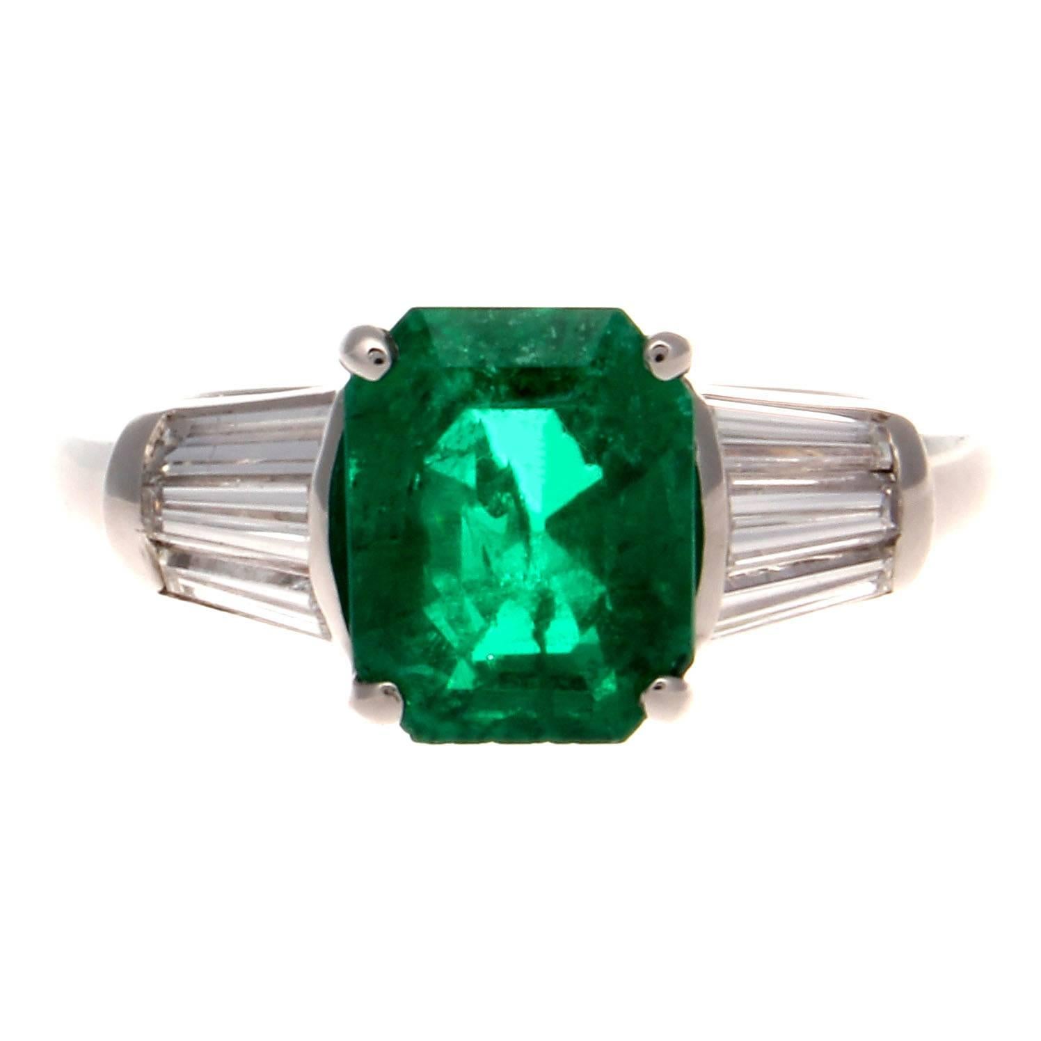 Embracing the ideology of traditional engagement rings while orchestrating a modern flare. Featuring a 2.54 carat emerald that radiates a rich forest green color that collectors lust for. Accompanied with an AGL certificate stating it is of