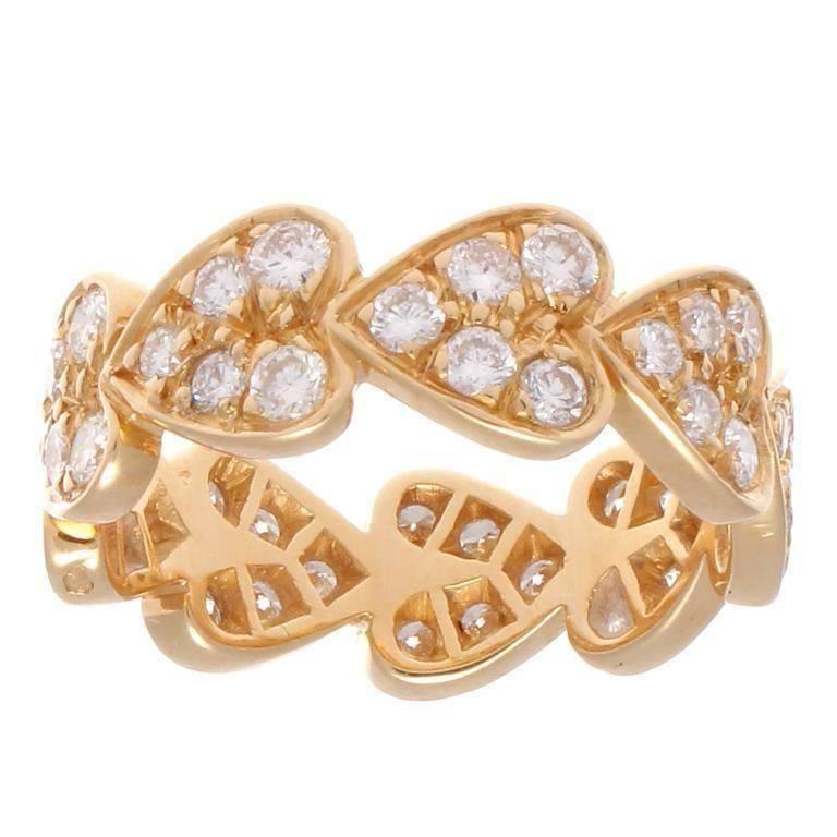 A creation of passion from Cartier. The circle of hearts and diamonds representing promises fulfilled. Crafted in 18k yellow gold. Signed Cartier, numbered and stamped with French hallmarks. 

Ring size 5.