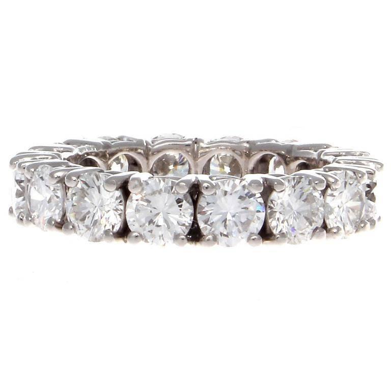 A timeless elegance radiates from this diamond platinum eternity ring. Featuring 16 perfectly matching round brilliant cut diamonds weighing approximately 4 carats all being E,F color, VS+ clarity. All masterfully set in its own platinum gallery.  