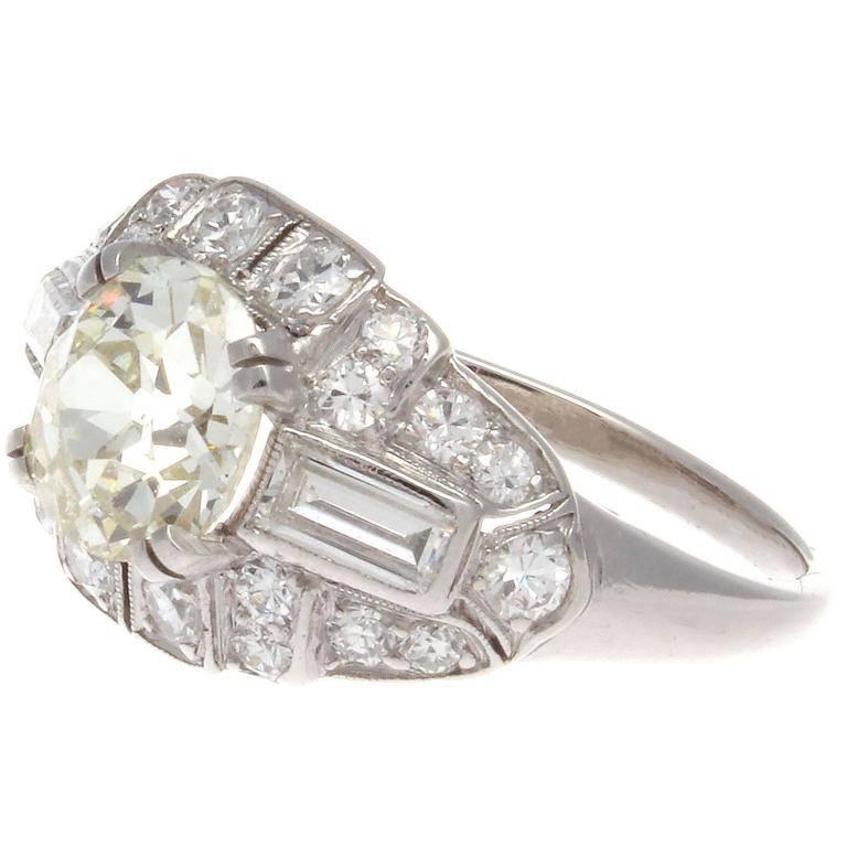 A classic look at the American art deco revolution of style. Featuring large shields of geometric shapes embedded with a mixture of round cut diamonds to perfectly fit and emphasize the 1.08 carat old European cut diamond that displays a warm,