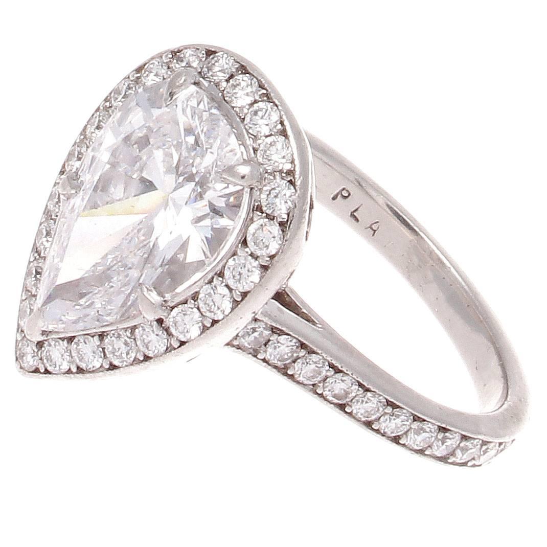 A lovely modern creation on the forever classic diamond engagement ring. Featuring a GIA certified 2.31 carat pear shaped diamond that is D color, VS2 clarity. Surrounded by a halo of perfectly matching clean white round cut diamonds. Crafted in