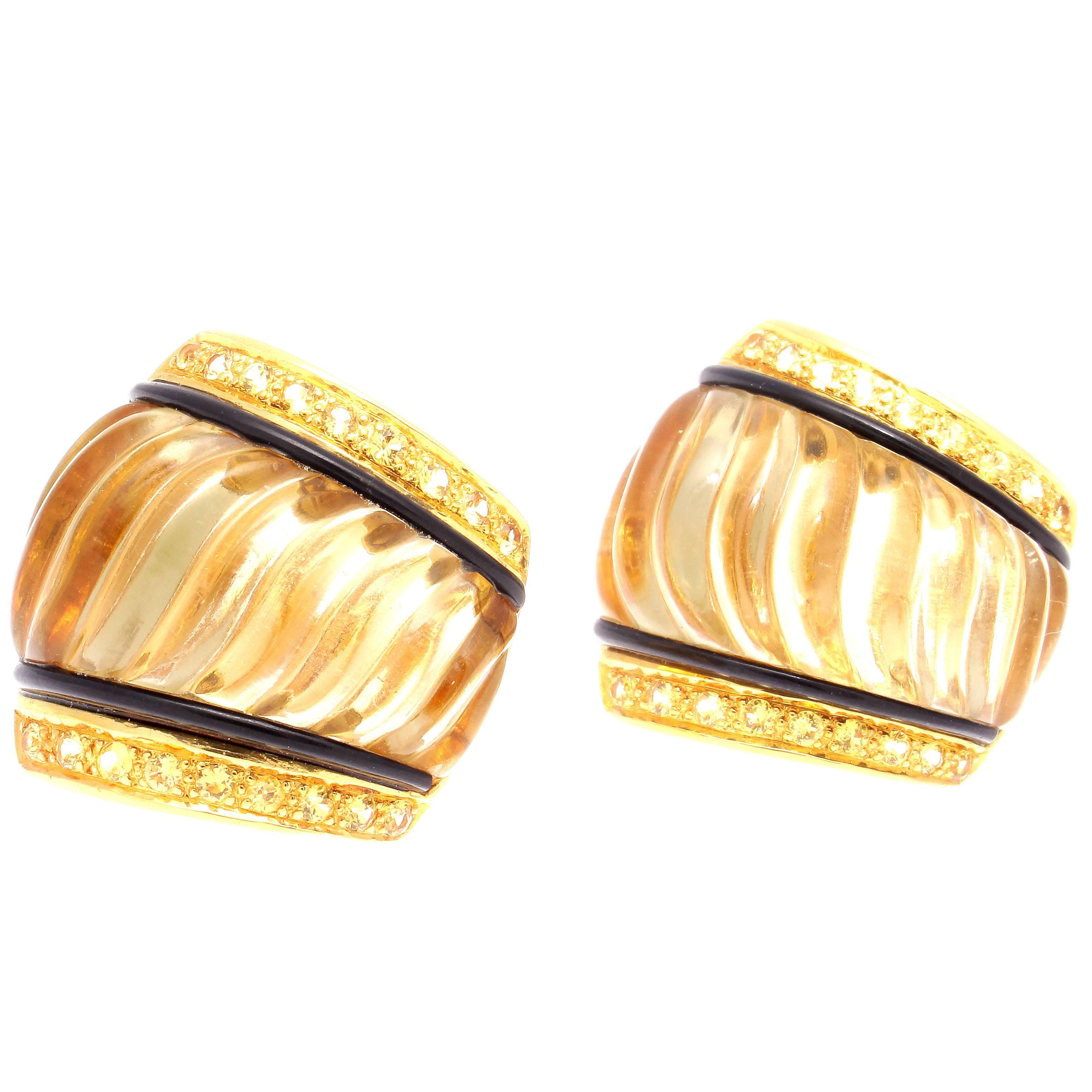 Pure design and colorful beauty. Featuring carved rock crystal perfectly complimented by vertical lines of jet black onyx and yellow sapphires on either side. Crafted in 18k yellow gold.