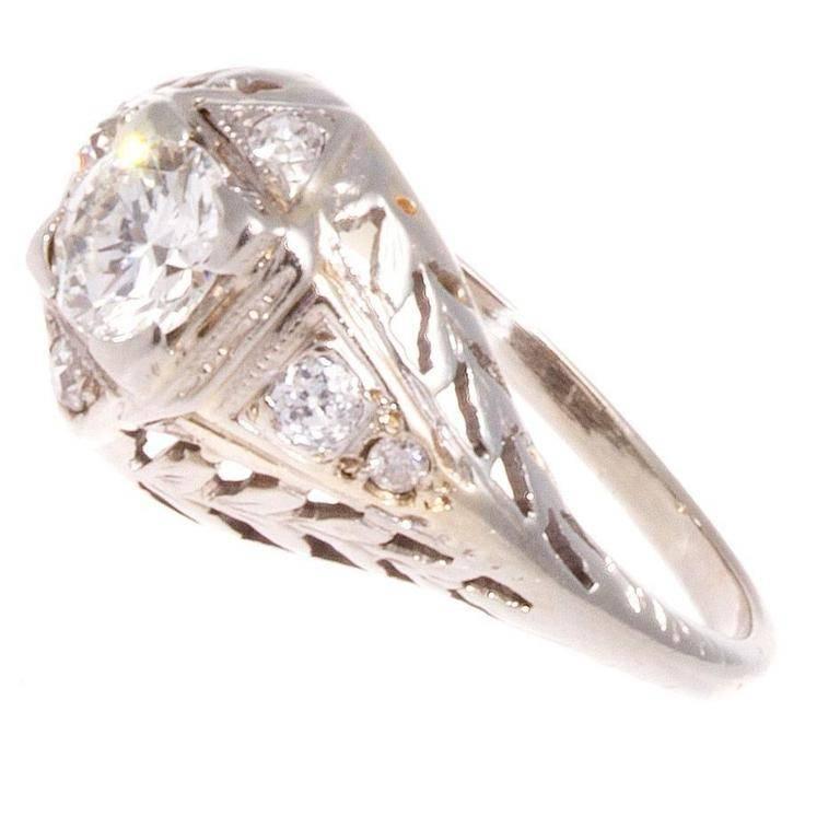 A gorgeous creation true to its art deco period. Featuring a 0.45 carat diamond that is captured between a web of four diamonds . Hand crafted in 18k white gold with intricate filigree design.

Ring size 5 3/4 and may be re-sized.